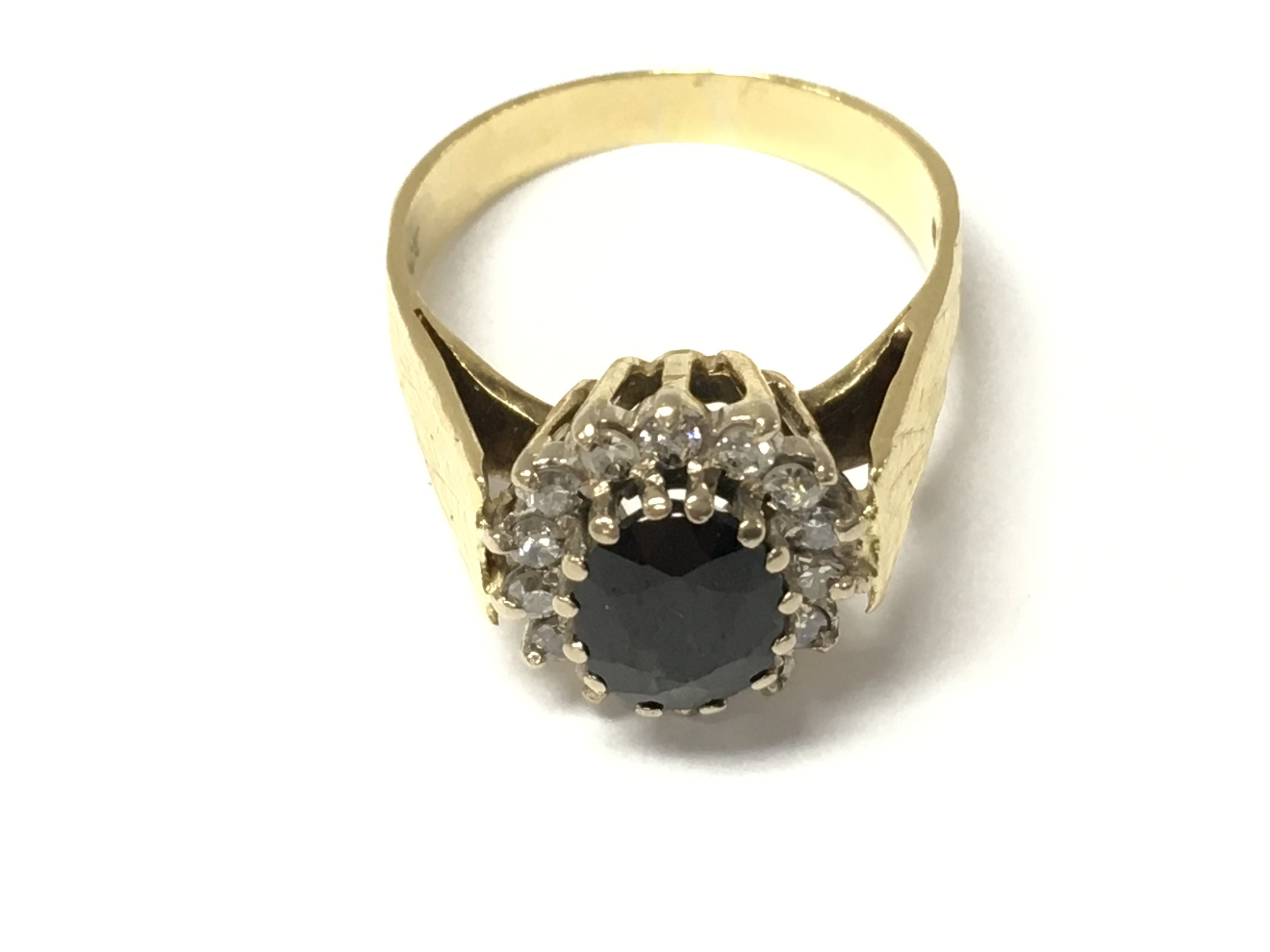 An 18ct gold sapphire and diamond cluster ring. Size M and 5.5g