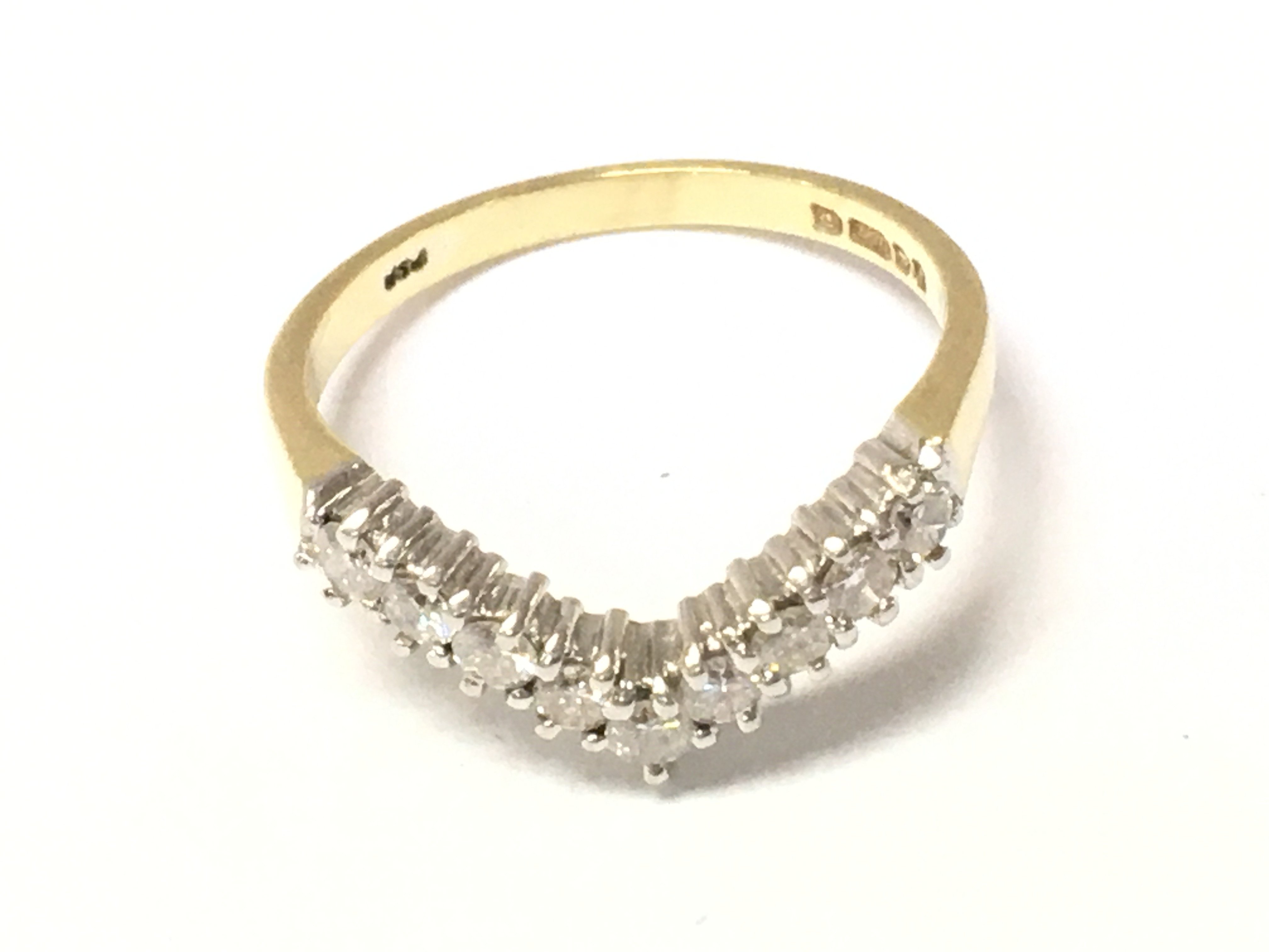 An 18ct gold diamond set wishbone ring. Size N and 3.17g Postage A