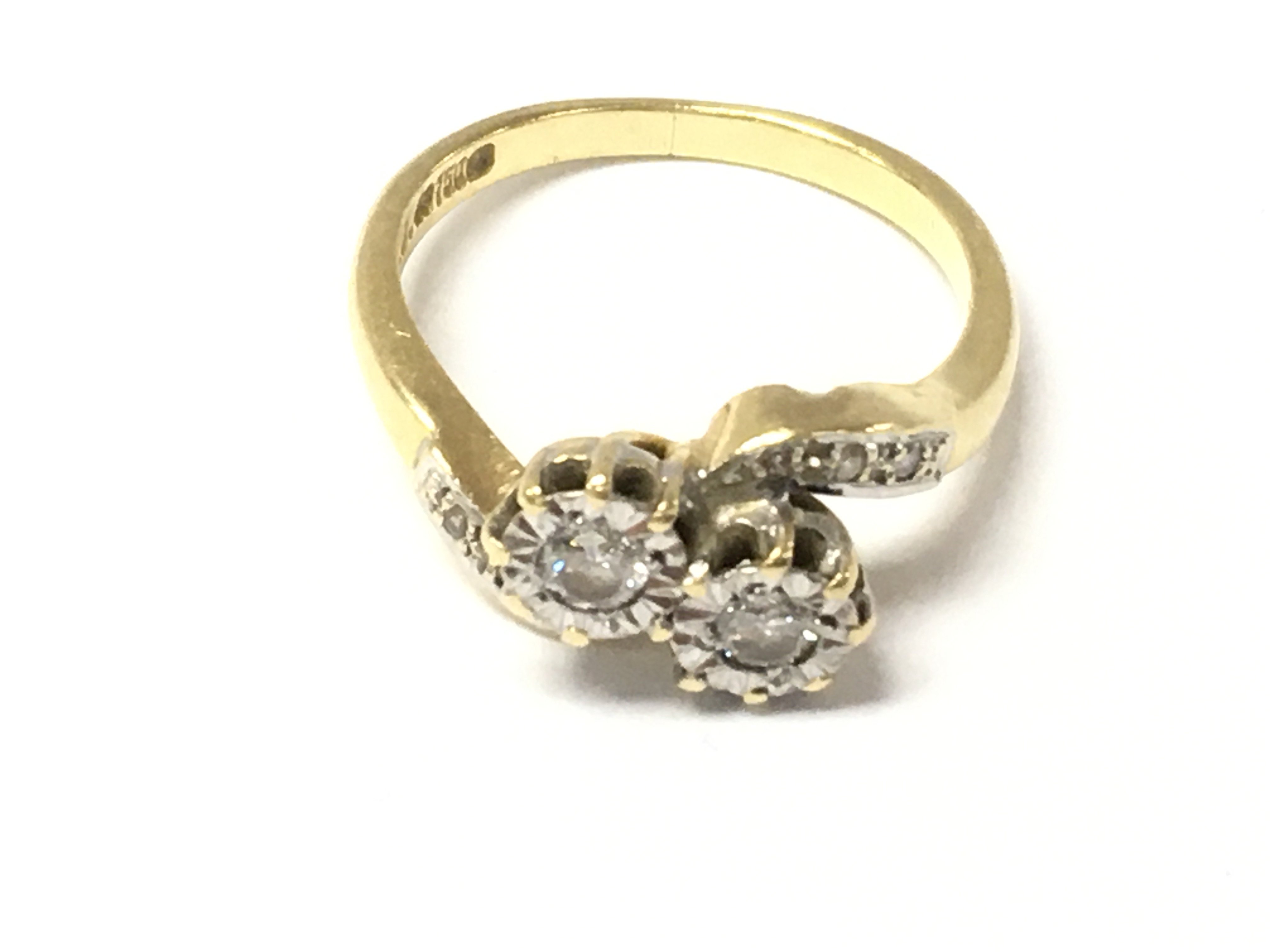 An 18ct gold diamond twist ring. Size N and 3.97g