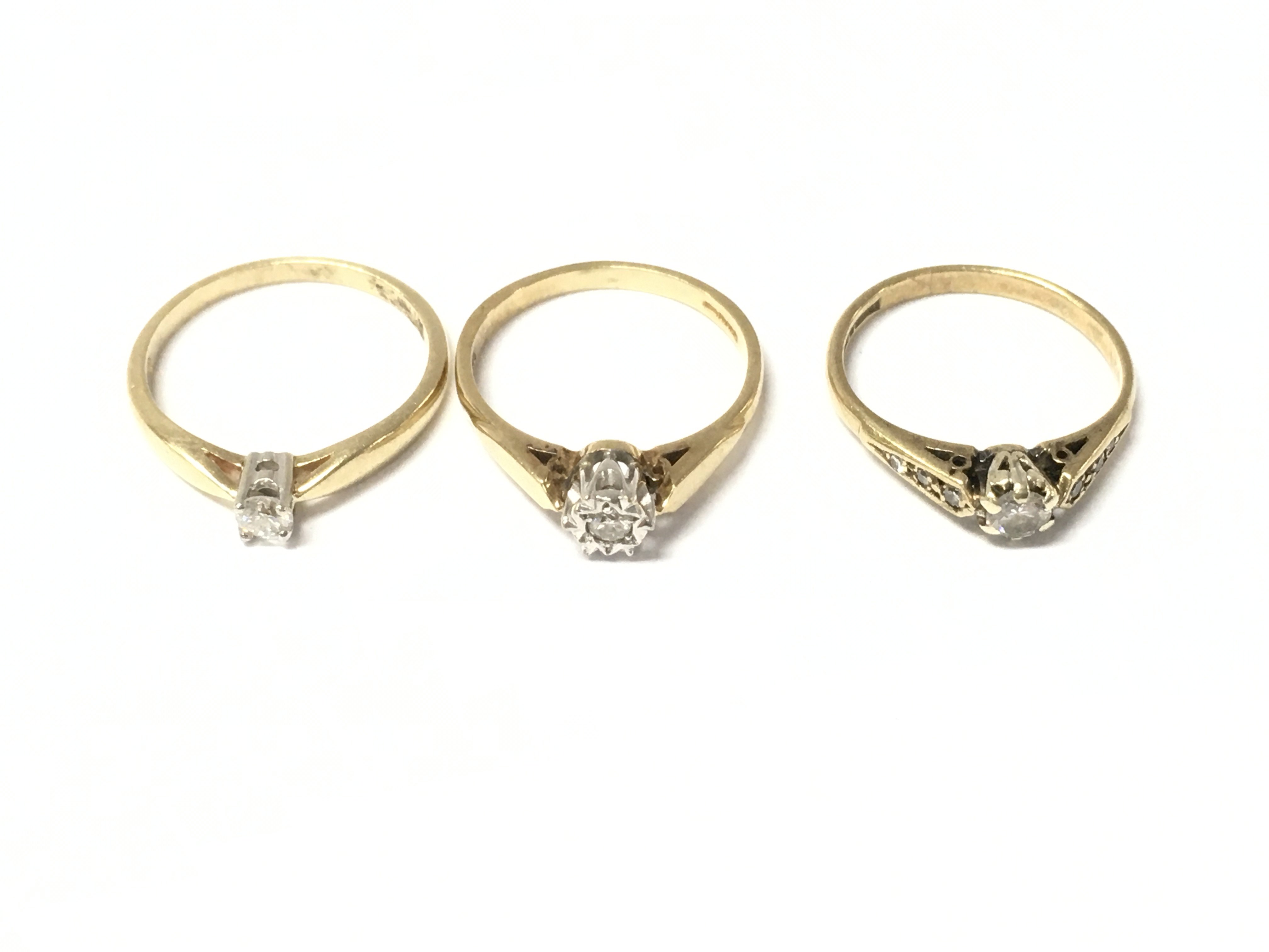 Three 9ct gold diamond solitaire rings. 5.54g total.