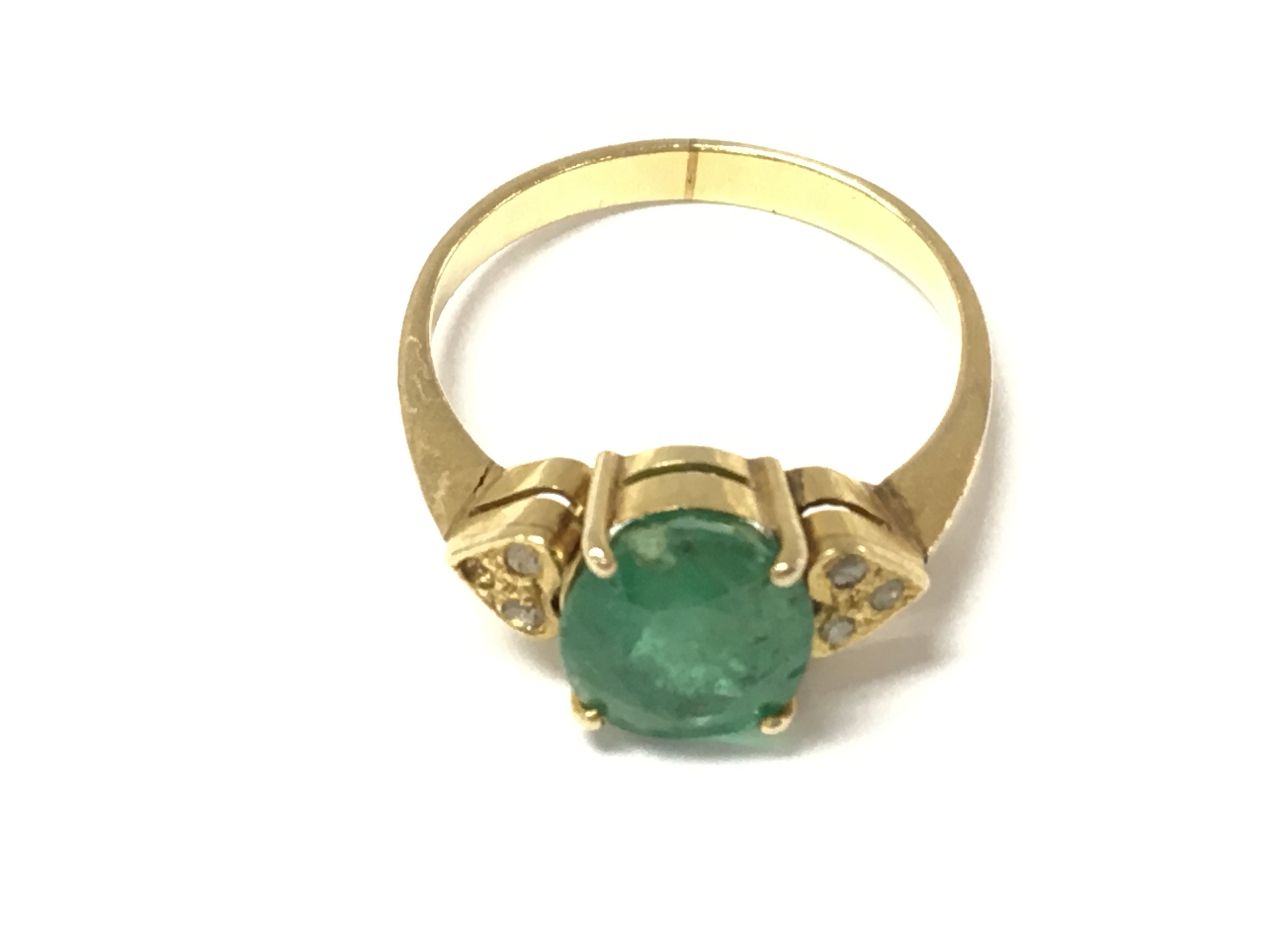 A 9ct gold emerald and diamond ring (one stone missing) size N and 2.6g