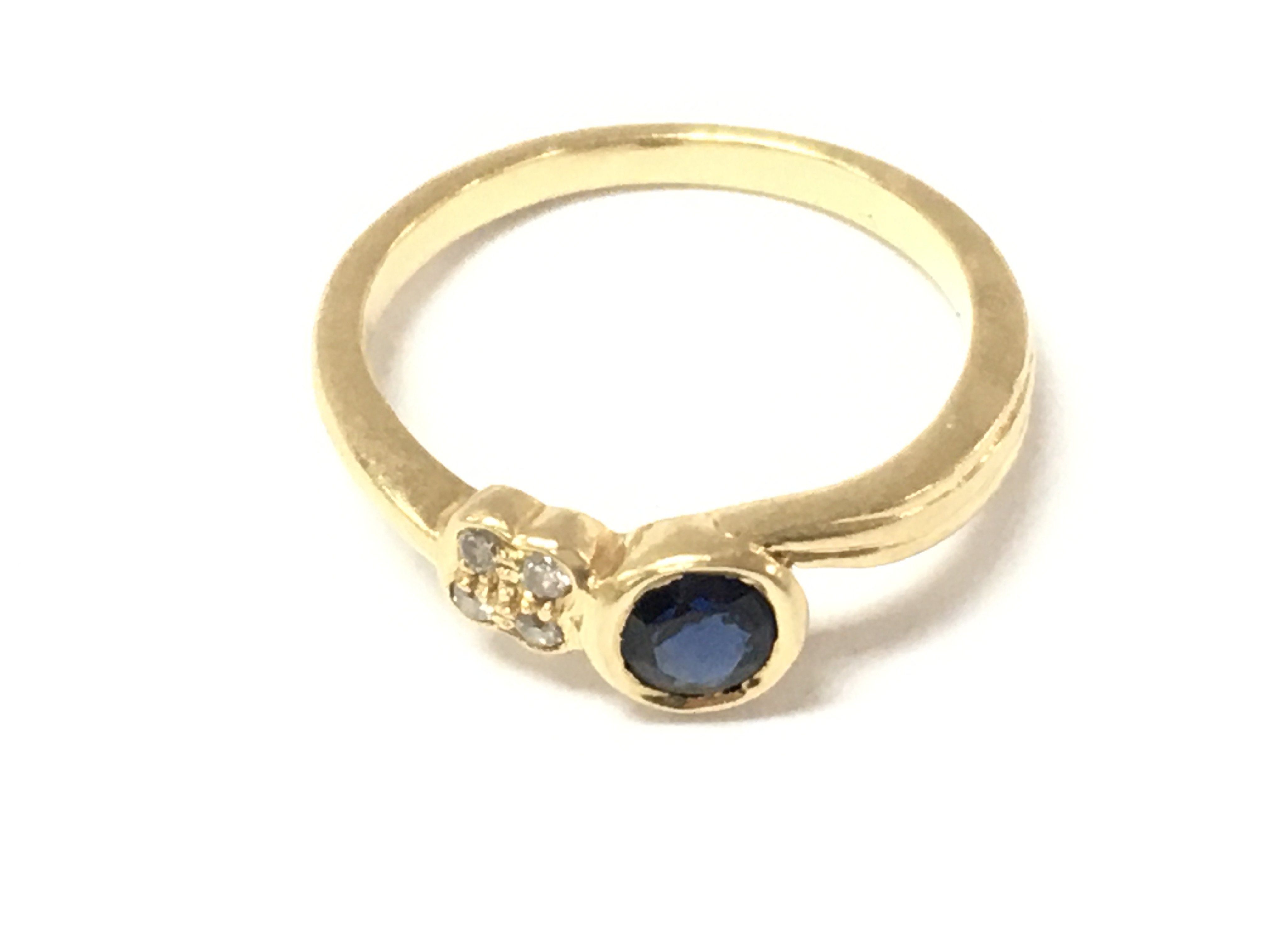 An 18ct gold sapphire and diamond ring. Size N and 3.52g