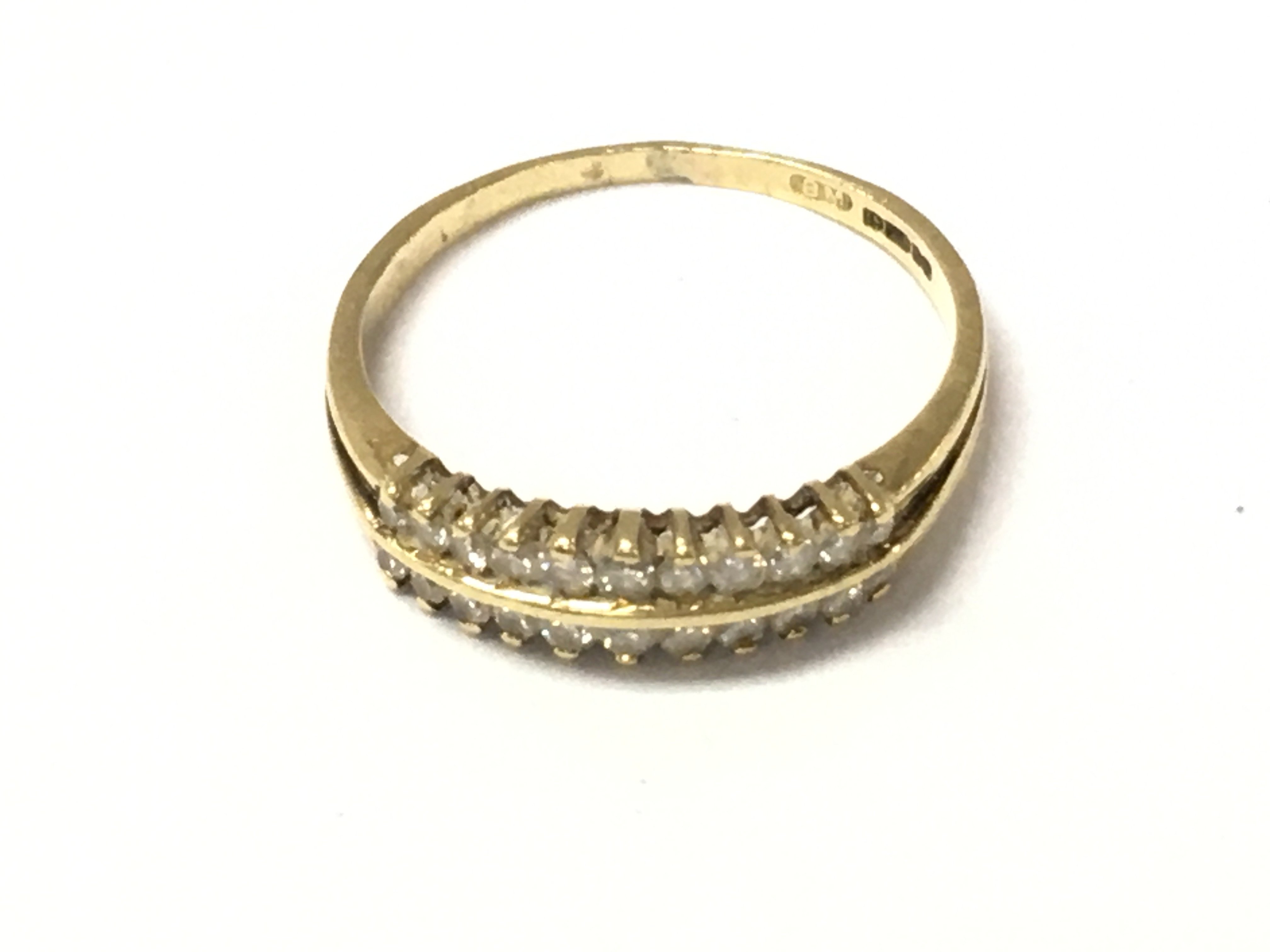 An 18ct gold double row diamond band ring. Size P 1/2 and 2.3g