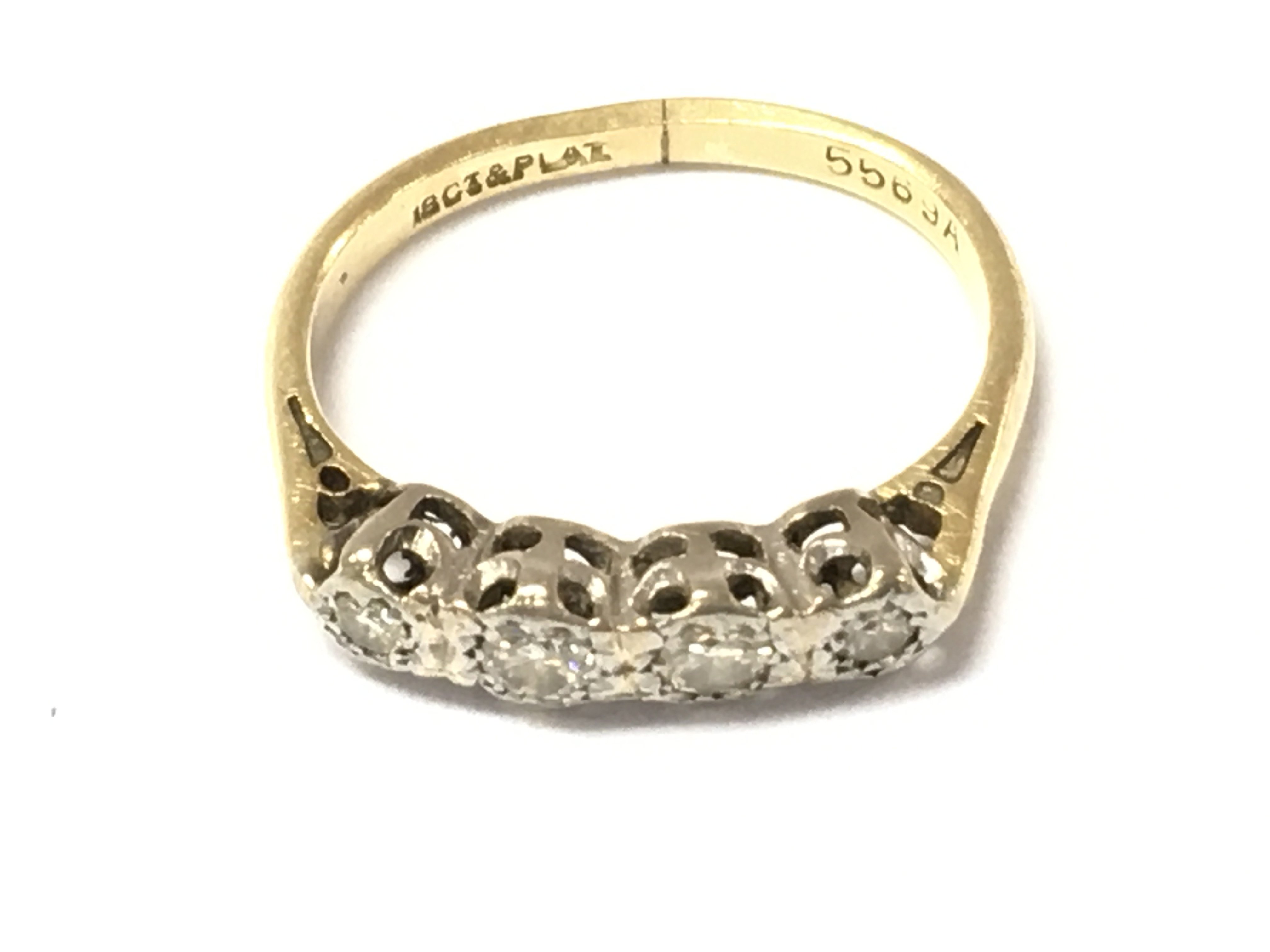 An 18ct gold four stone diamond ring. Size K and 2.75g note ring is bent. Postage A