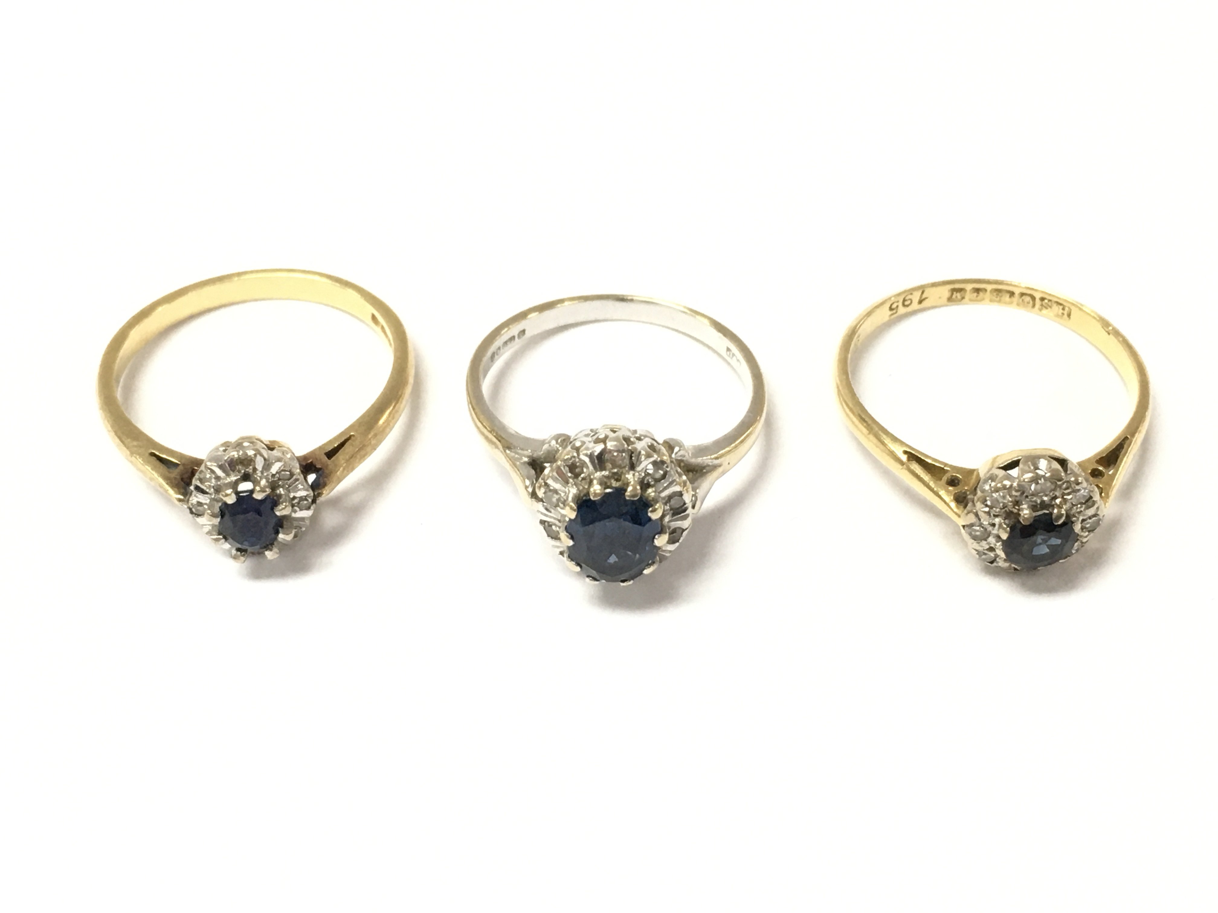 Three 18ct gold sapphire and diamond cluster rings. 8.5g Postage A