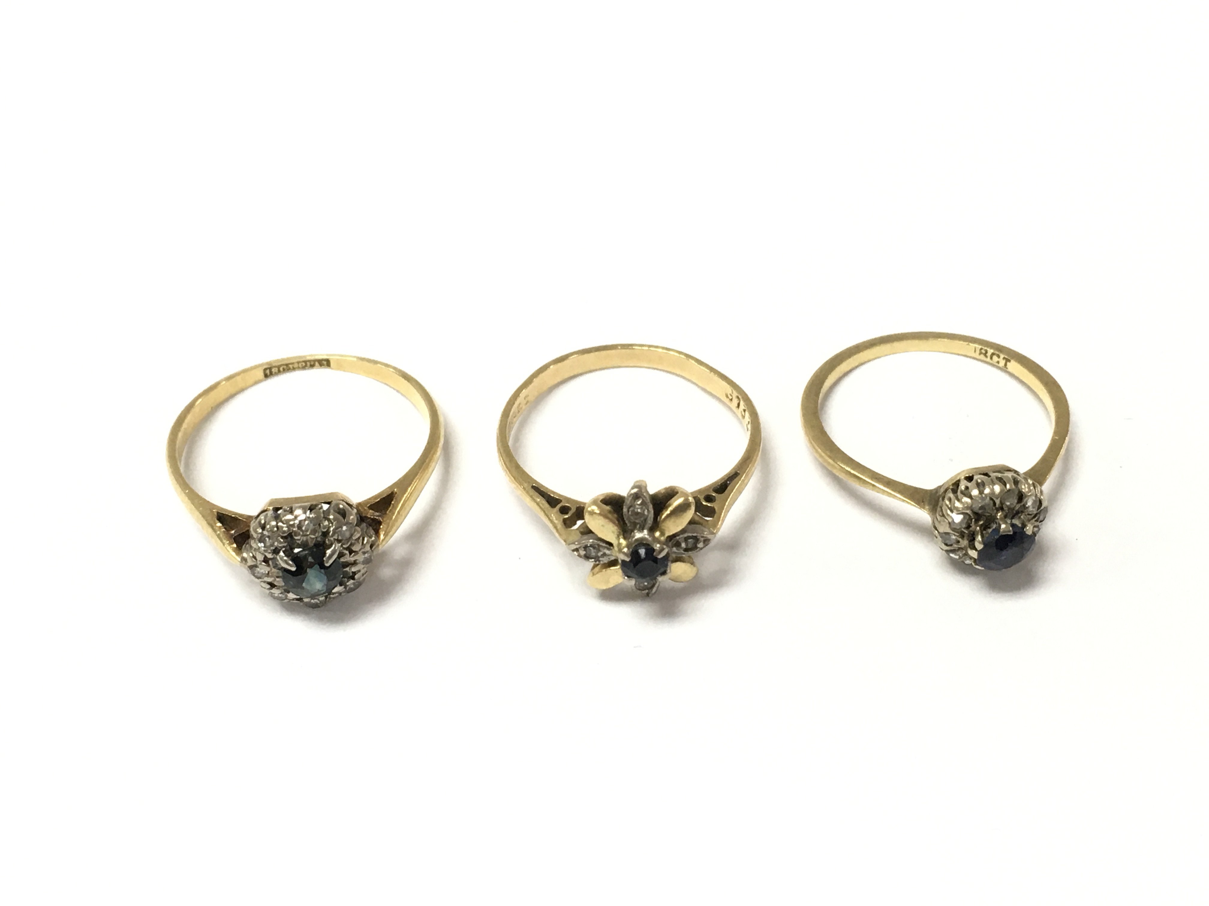 Three 18ct sapphire and diamond cluster rings. 6.80g