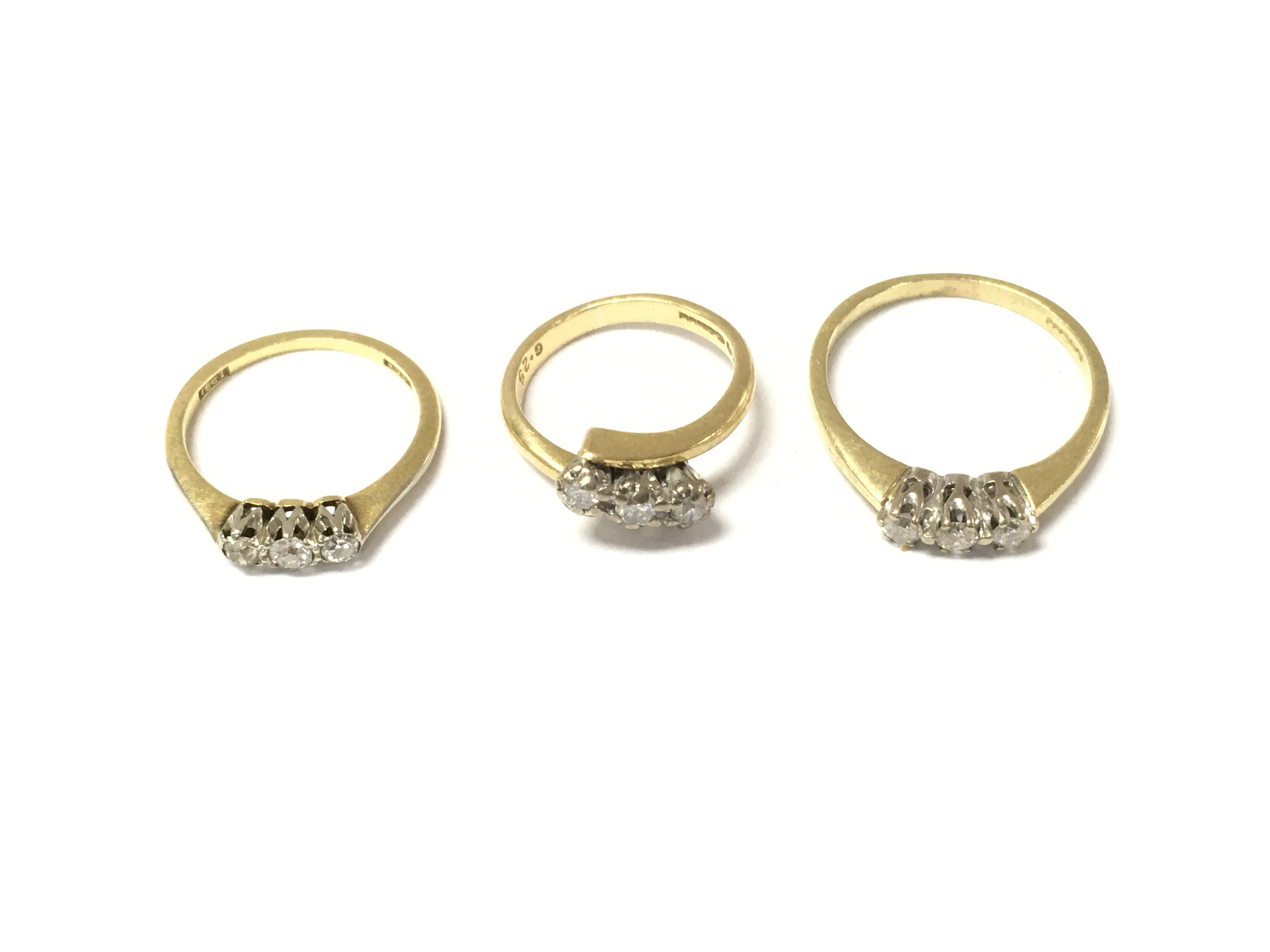 Three 18ct gold 3 stone diamond rings. 9.19g
