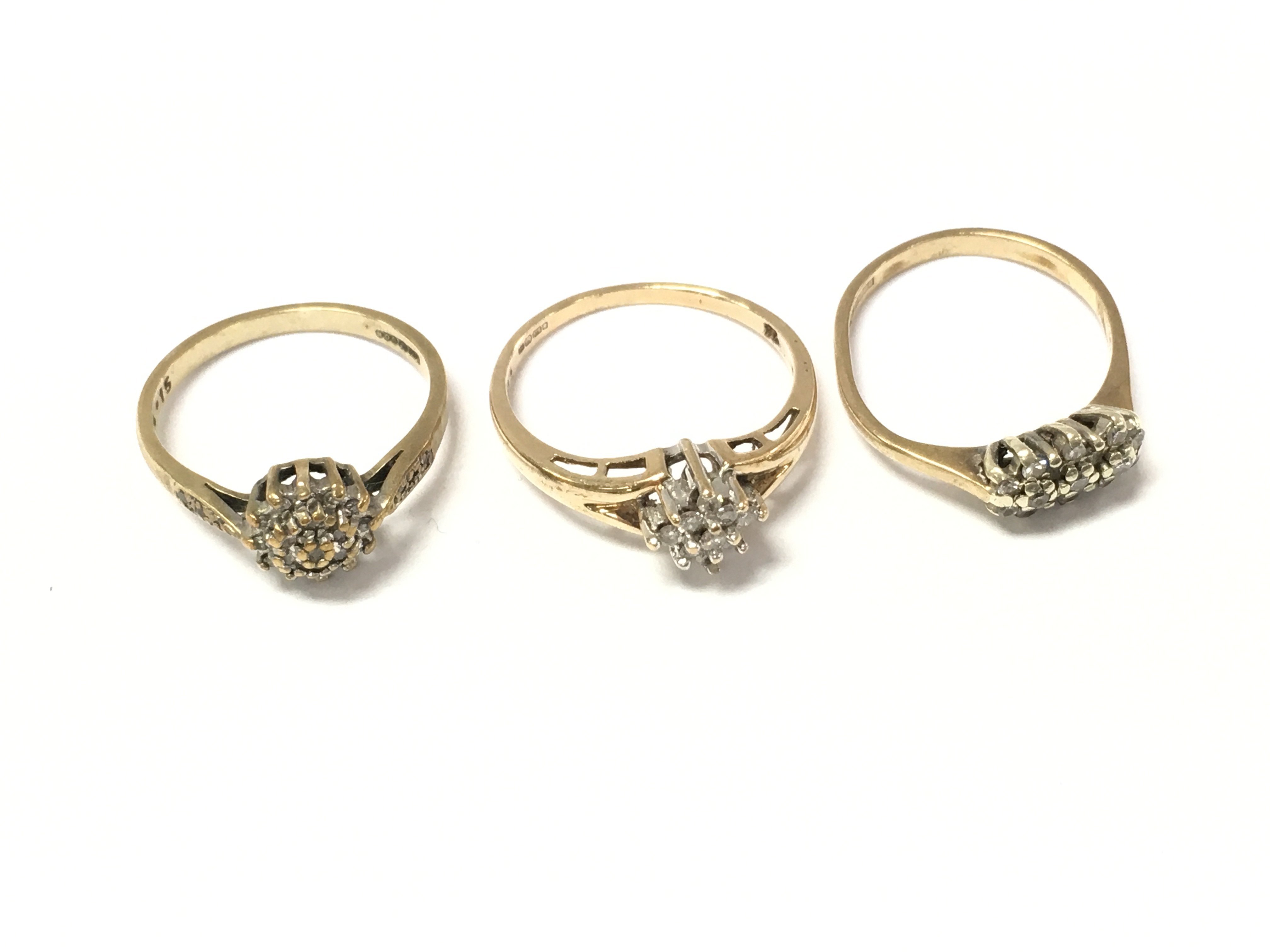 Three 9ct gold diamond cluster rings. 5.4g