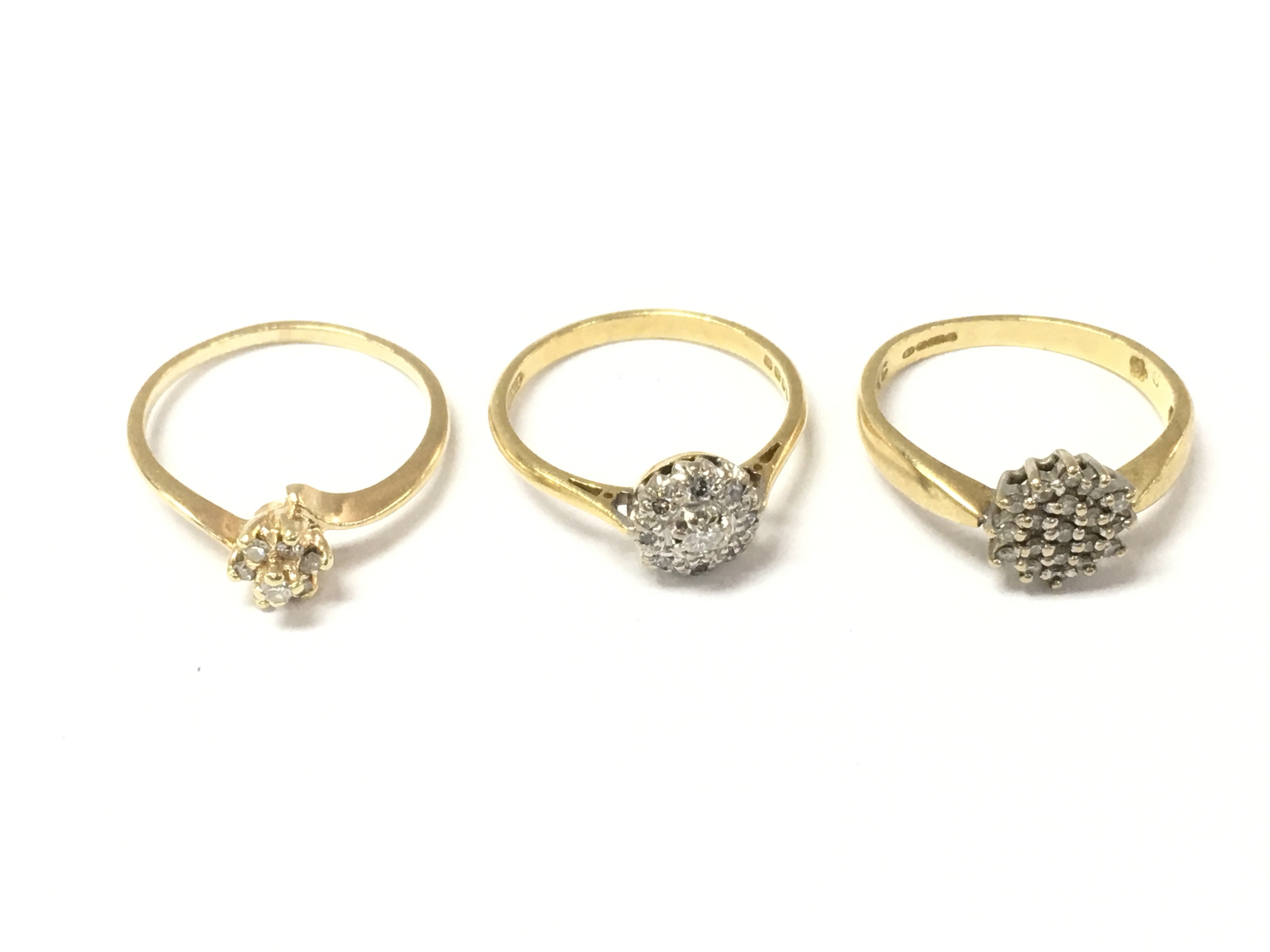 Three 18ct gold diamond cluster rings. 6.82g