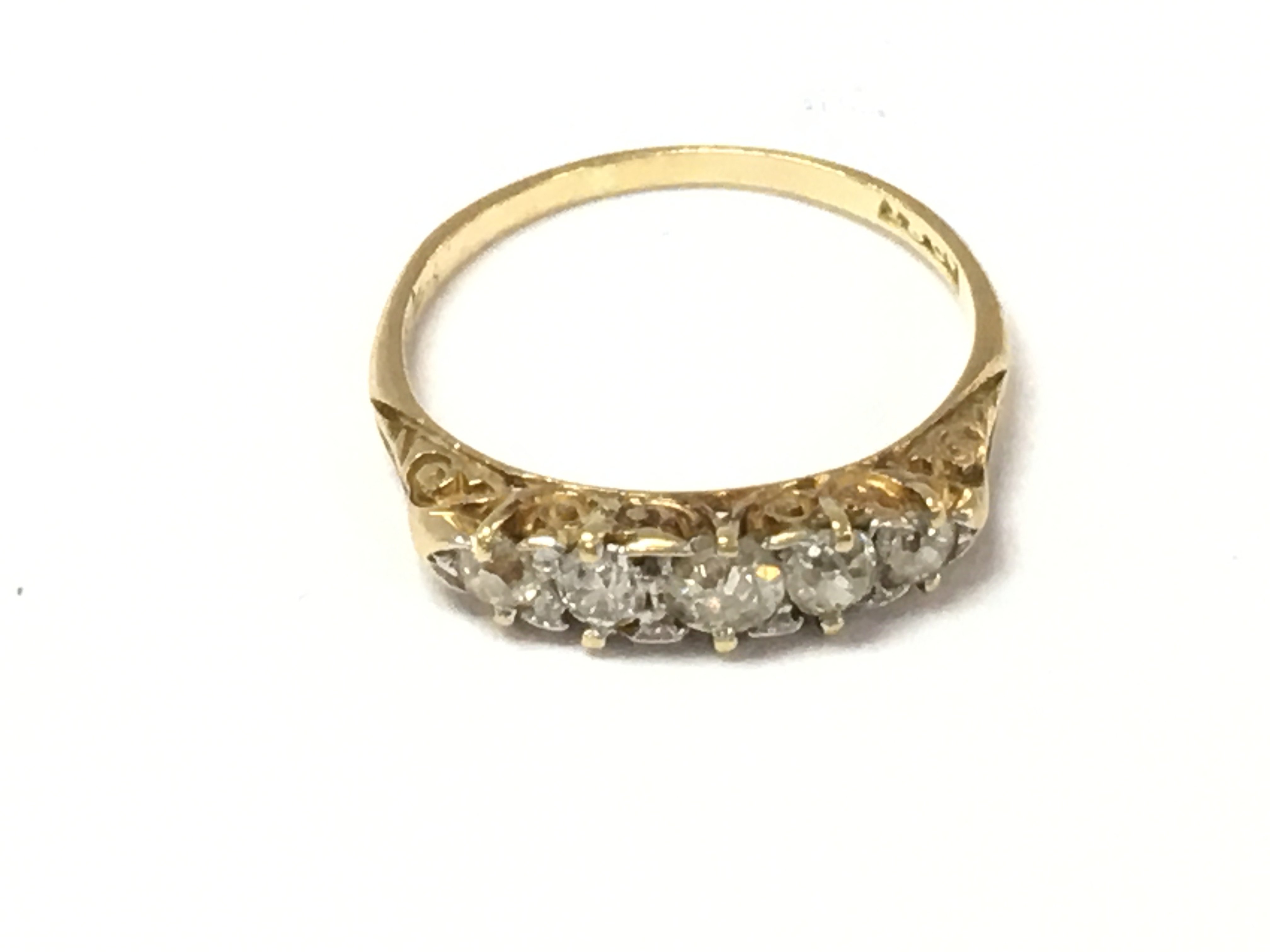 An 18ct gold 5 stone diamond ring. Size N and 2.10g