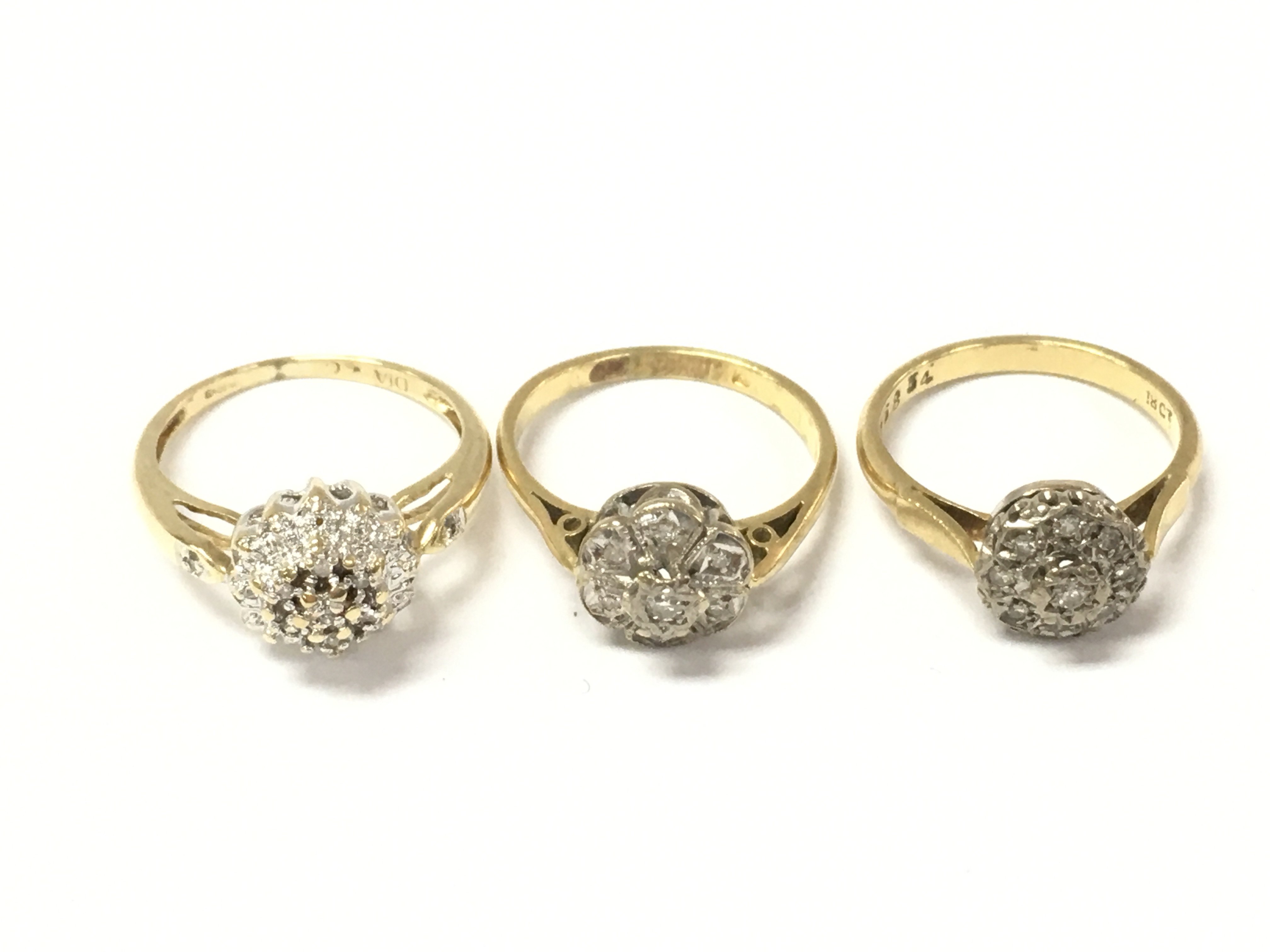 Three 18ct gold diamond cluster rings. 8.89g