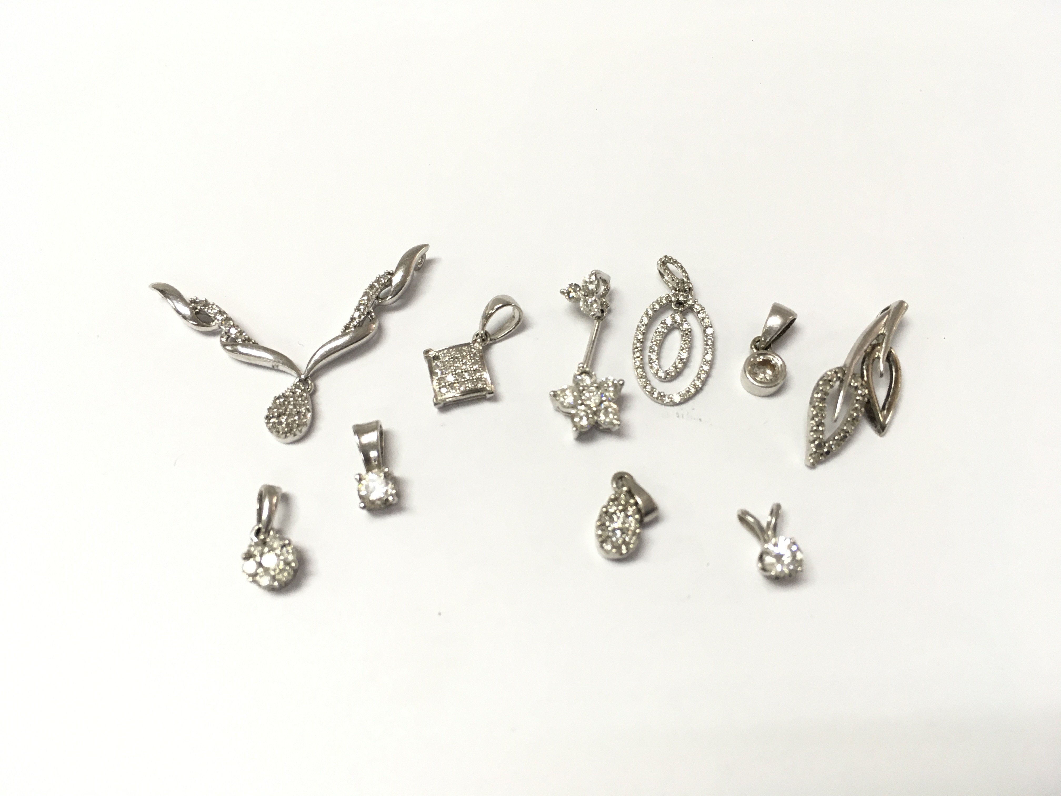 A collection of 9ct white gold diamond pendants. 6.72g