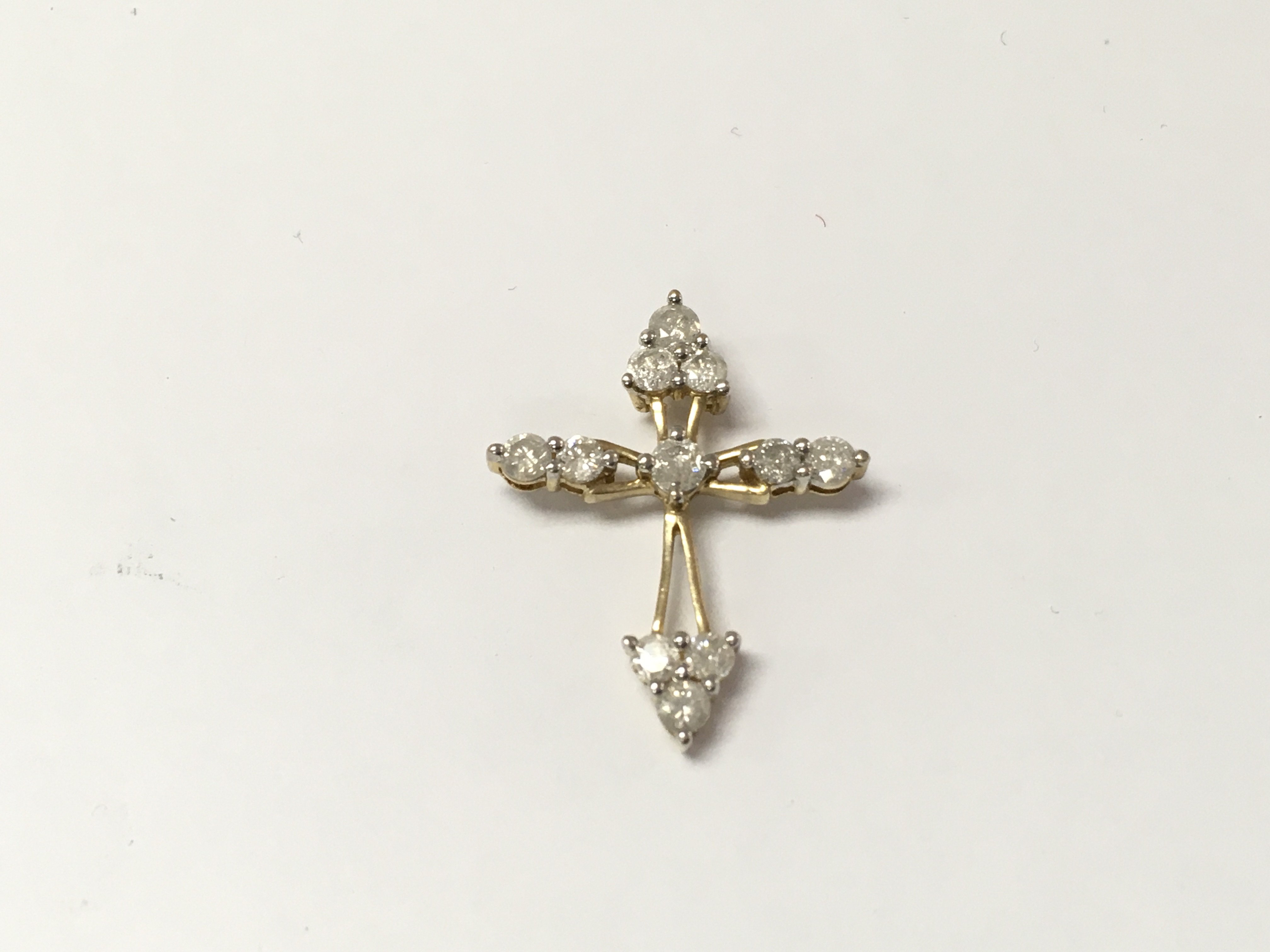 A 9ct gold diamond cross pendant. 1.83g