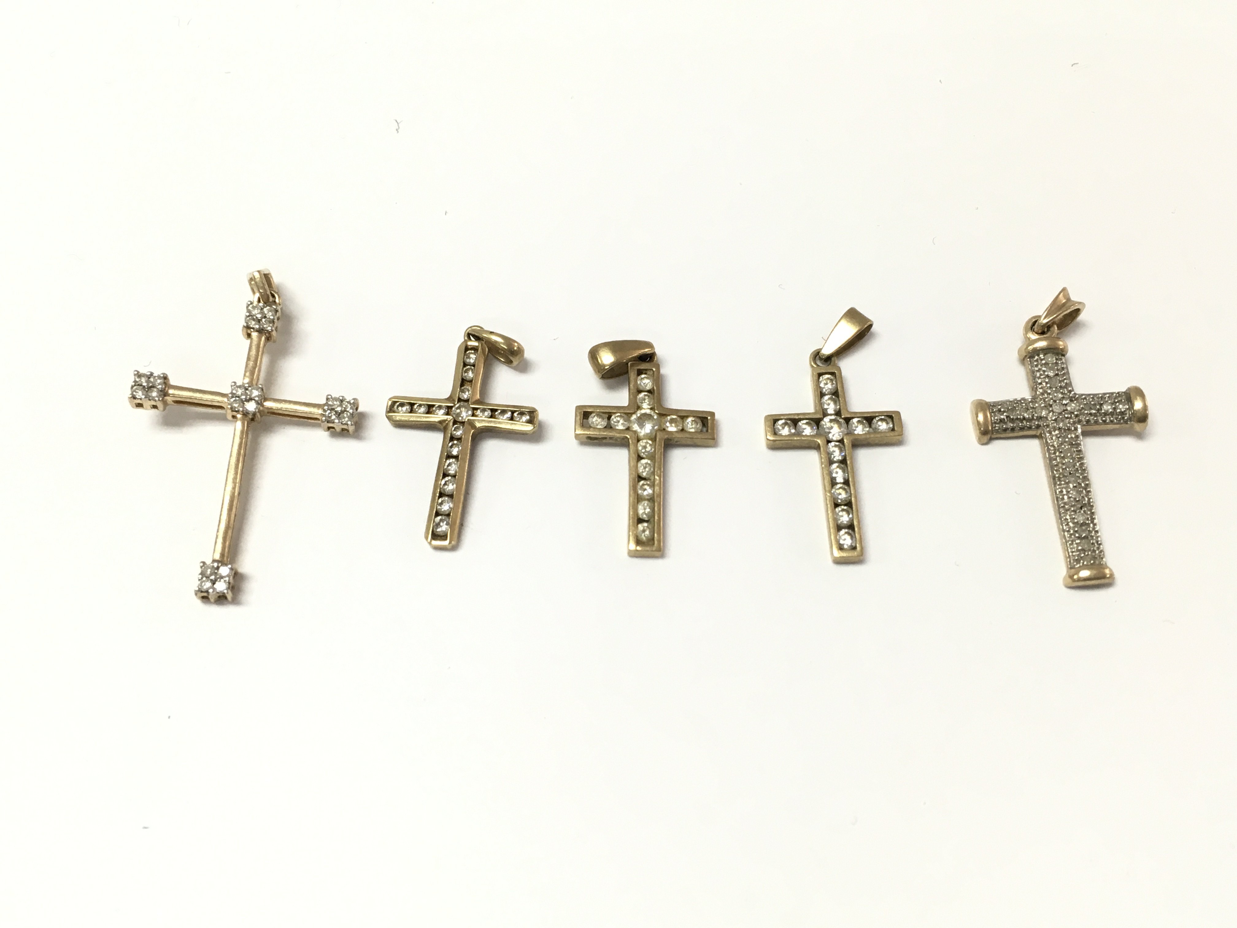 A collection of 9ct gold diamond pendants. 10.92g