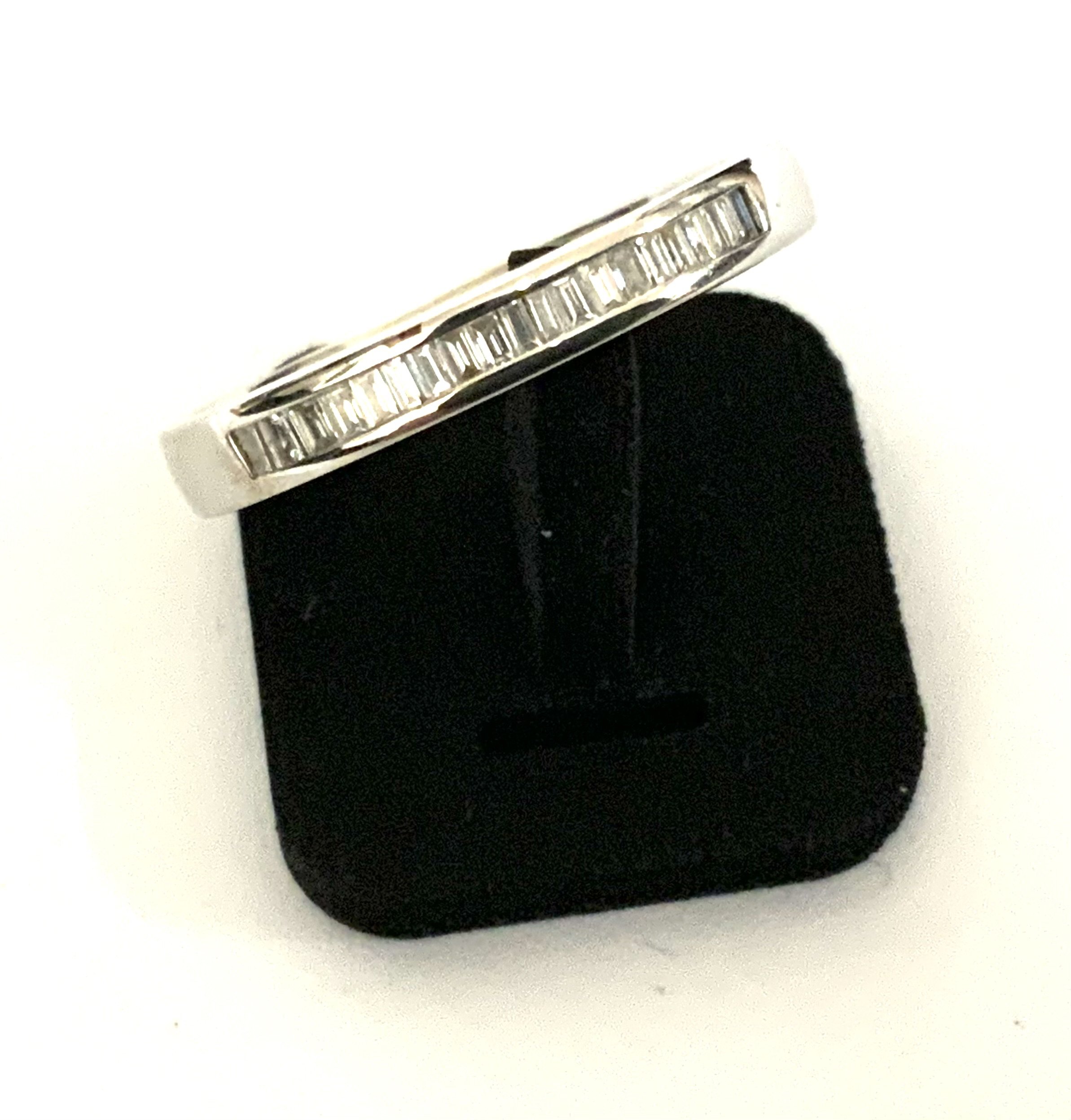 An 18ct white gold and diamond baguette ring, Size N. (A)