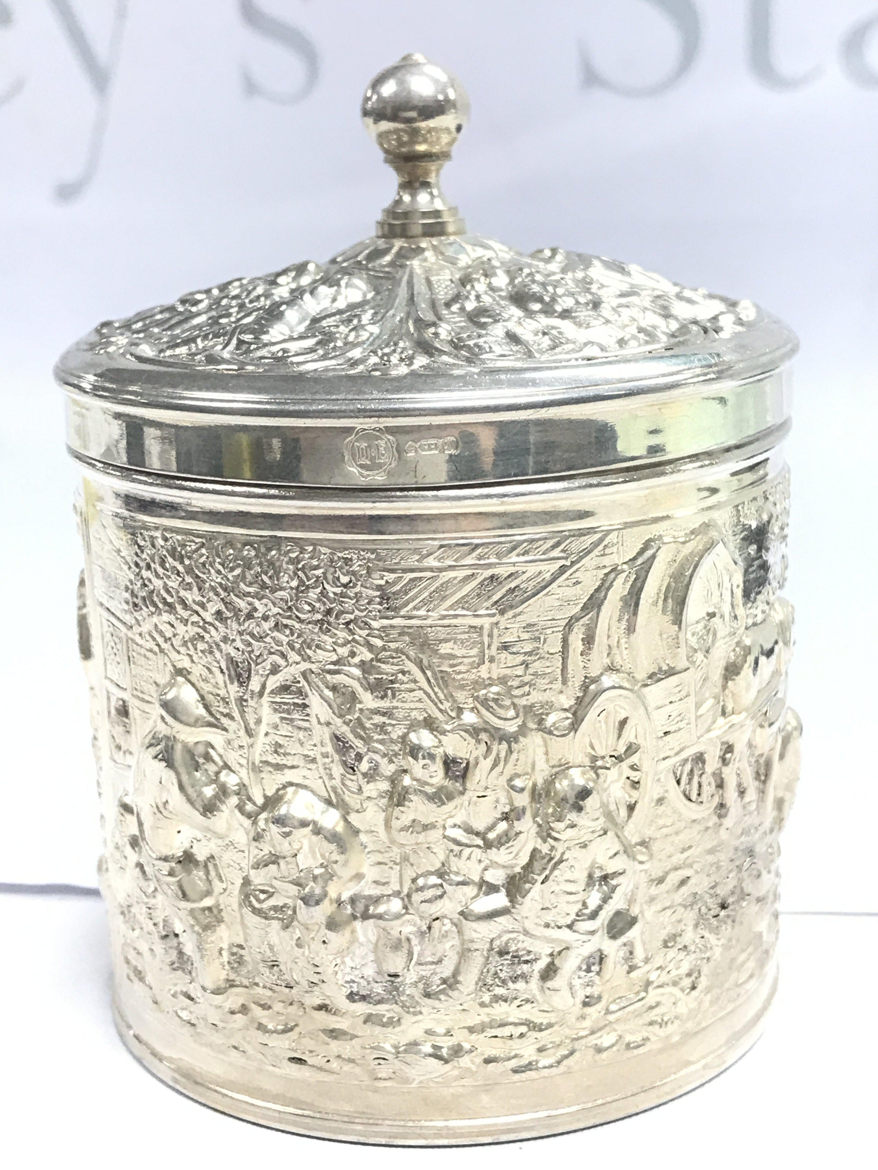 An ornate silvered container , marked DE.HH.90. Postage category B