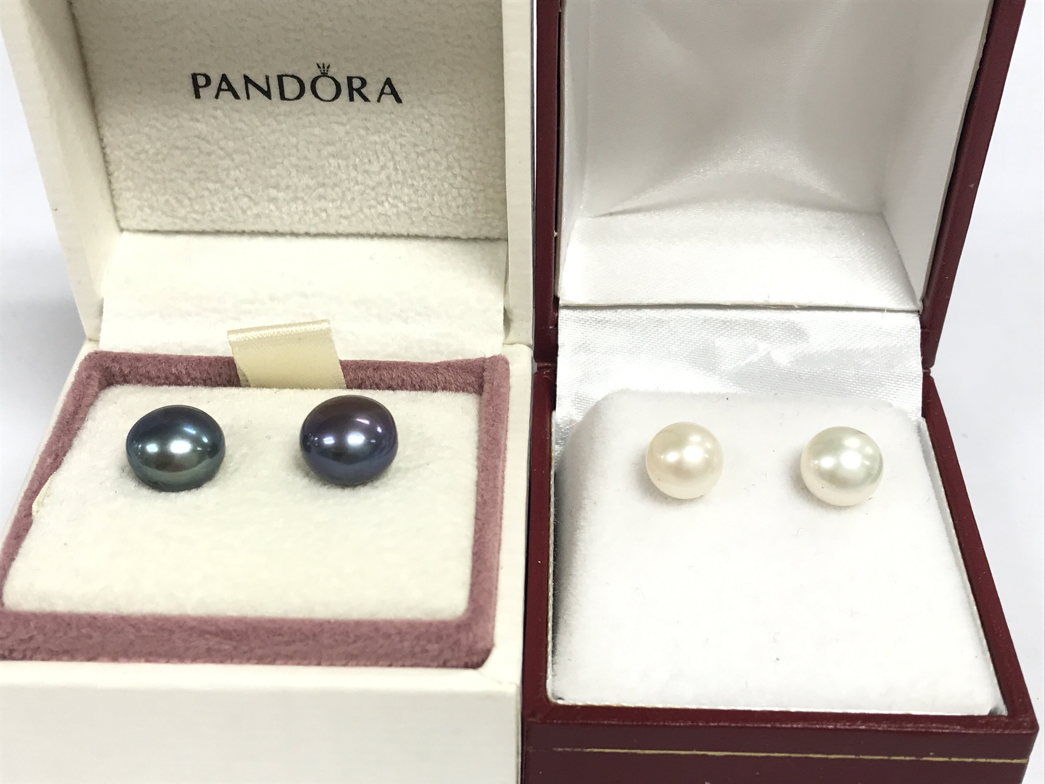 Two pairs of 9ct gold cultured Pearl earrings . Black and cream . 3.5g total weight. Postage category a