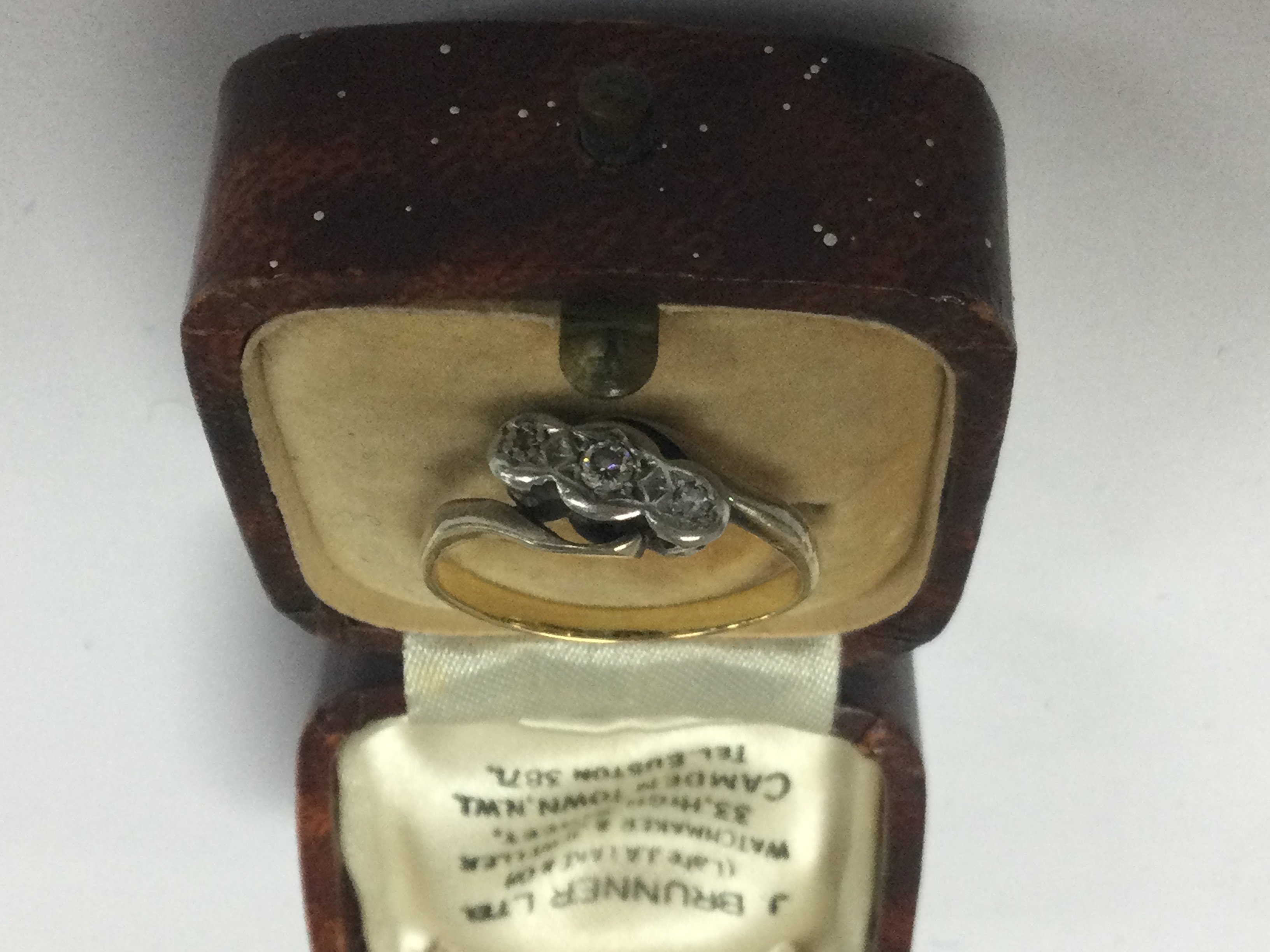 A unmarked ring inset with diamond chips .