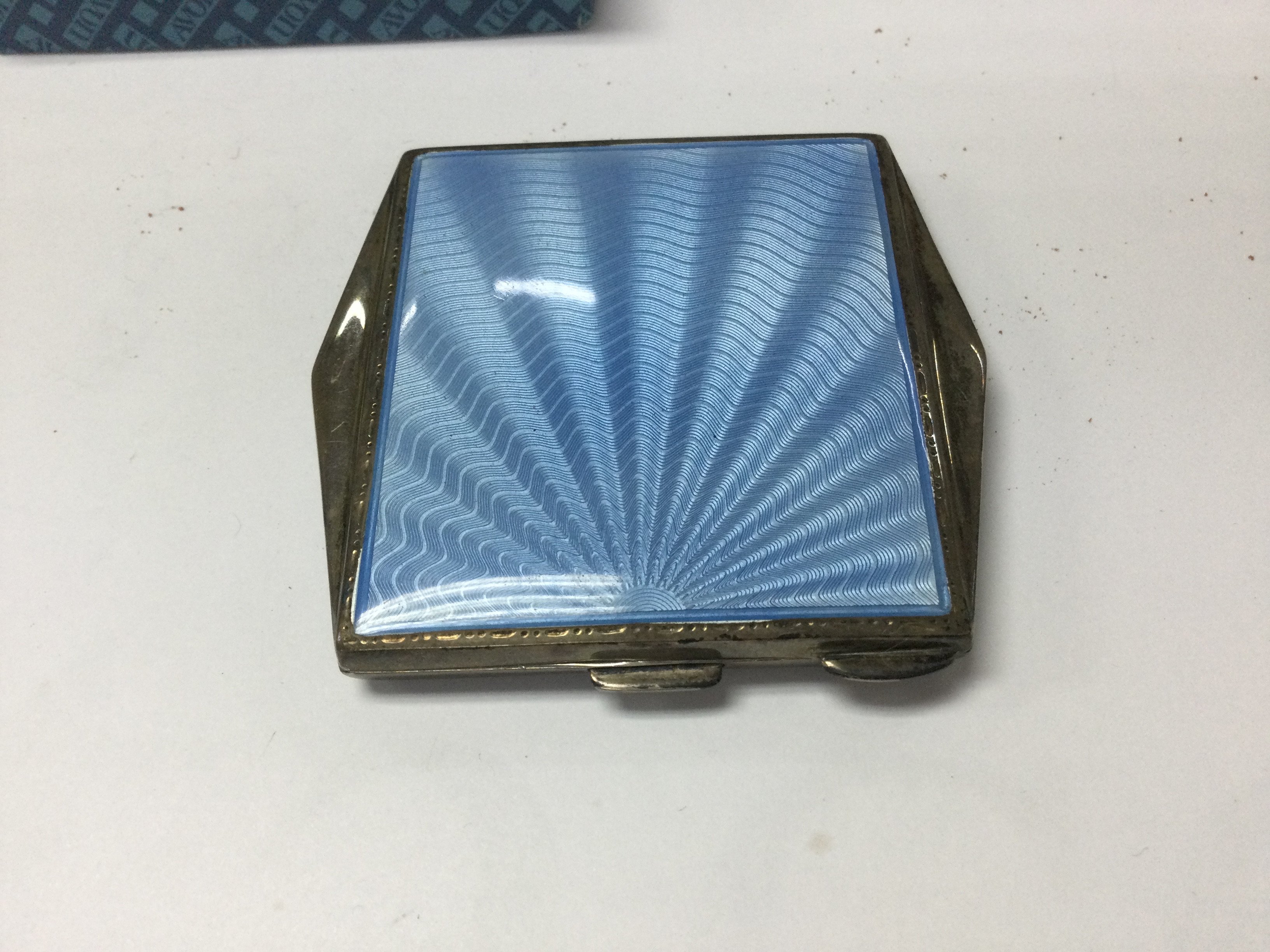 A silver and enamel compact .