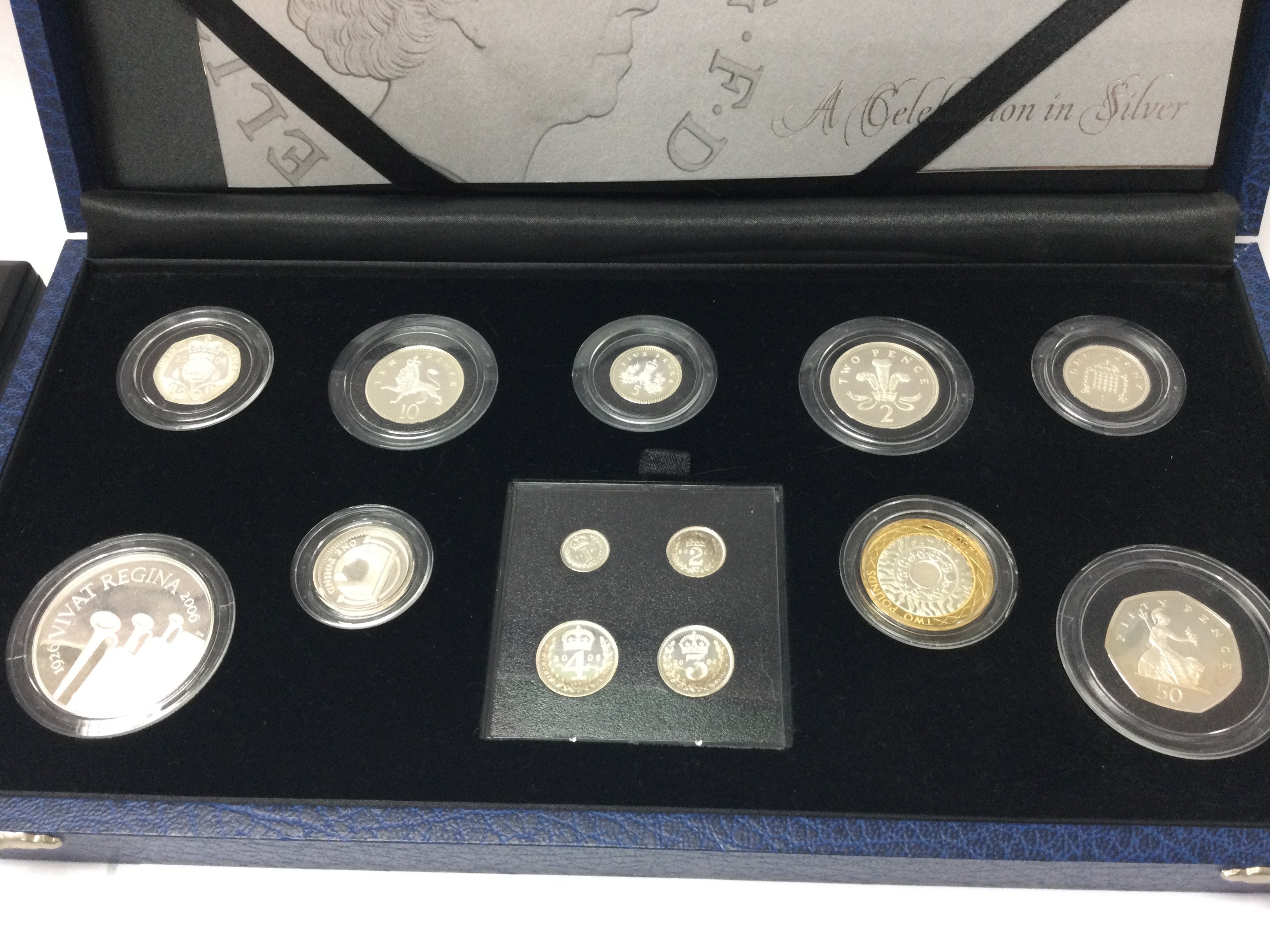 A case set of silver coins The Queens 80 th birthday day collection.