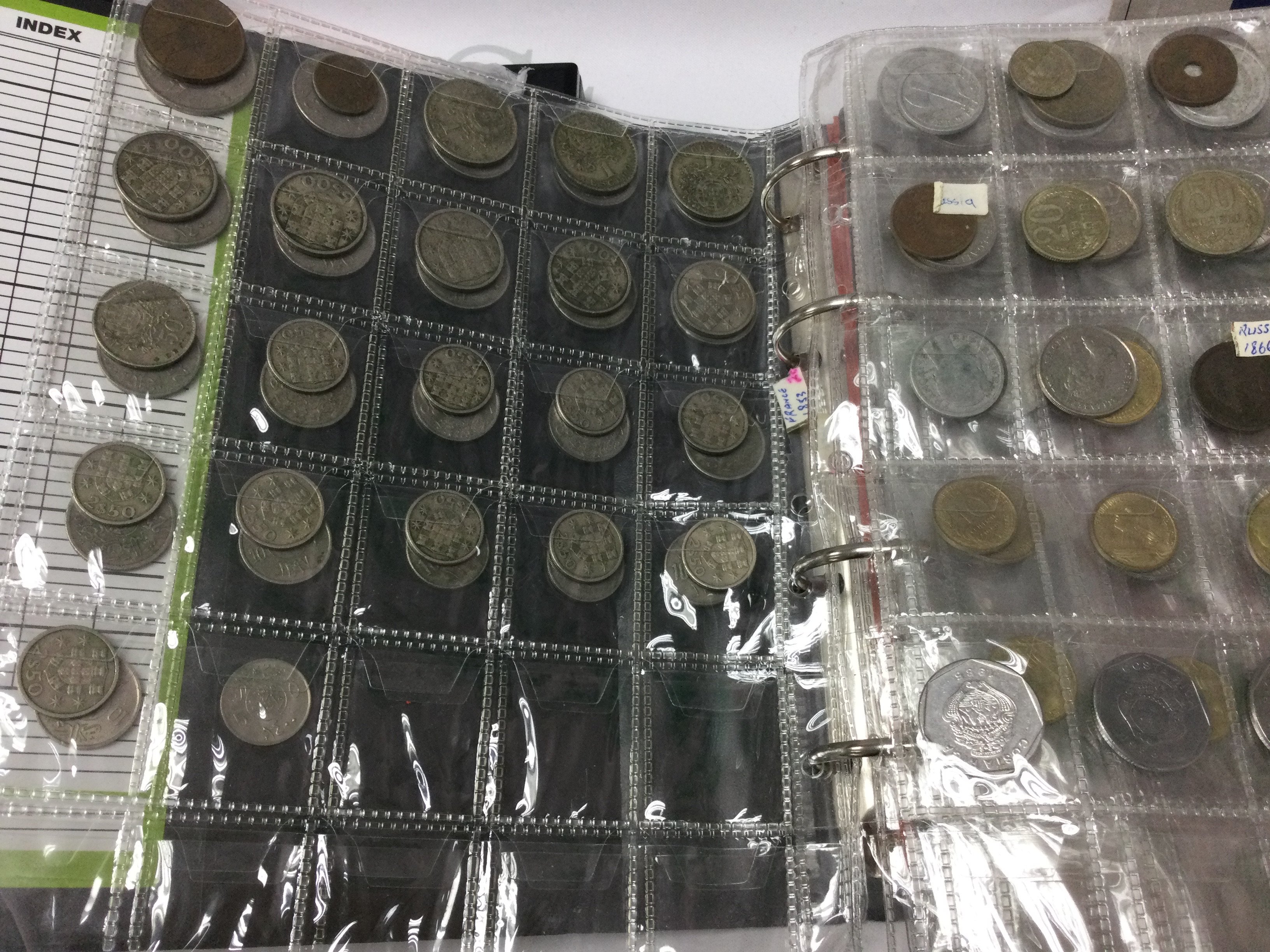 A box containing cased Royal mint Proof coin collections together with two albums of British and world coins .
