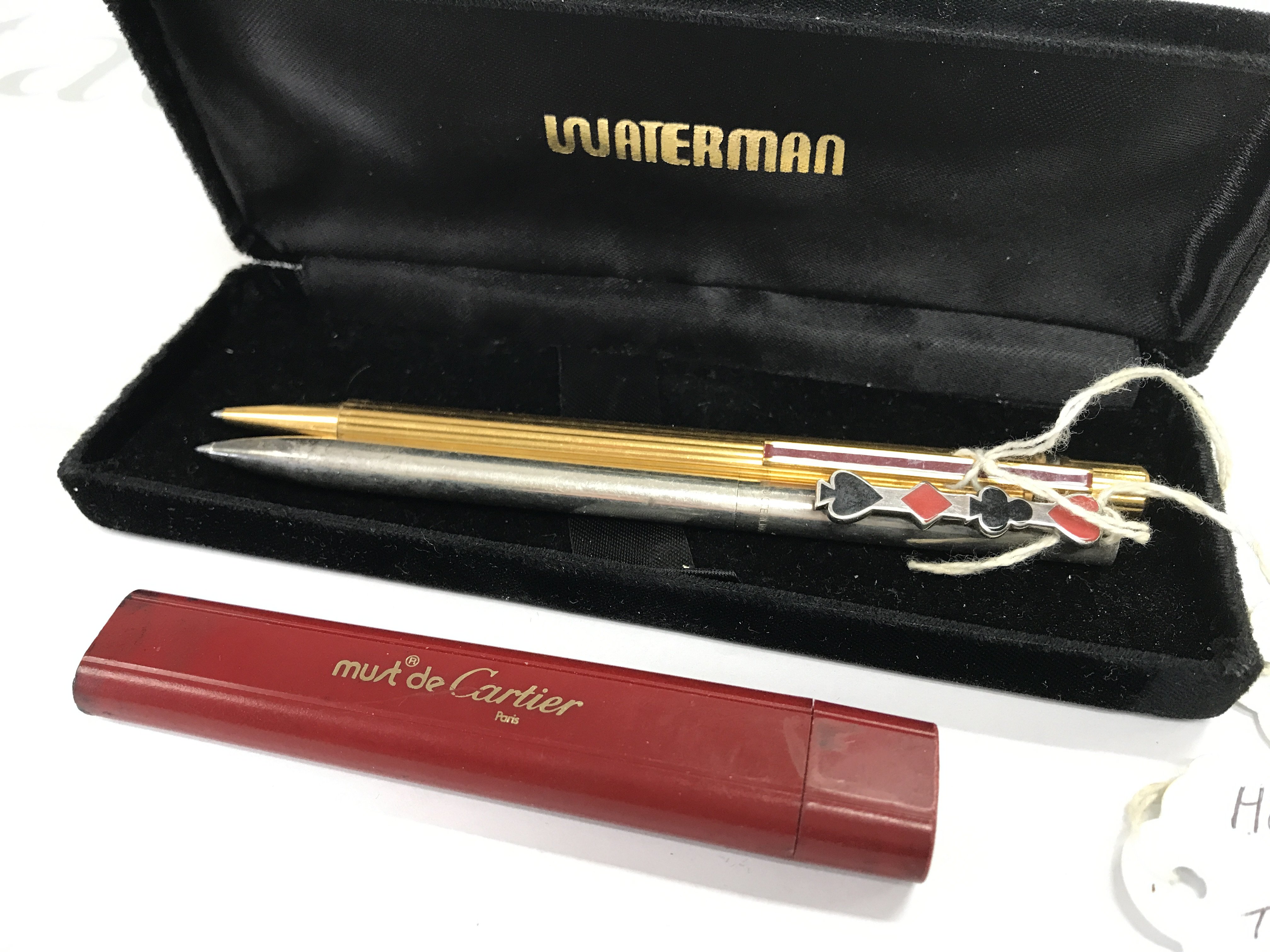 A Cartier pen with case, hallmarked silver Tiffany pen. Postage category A
