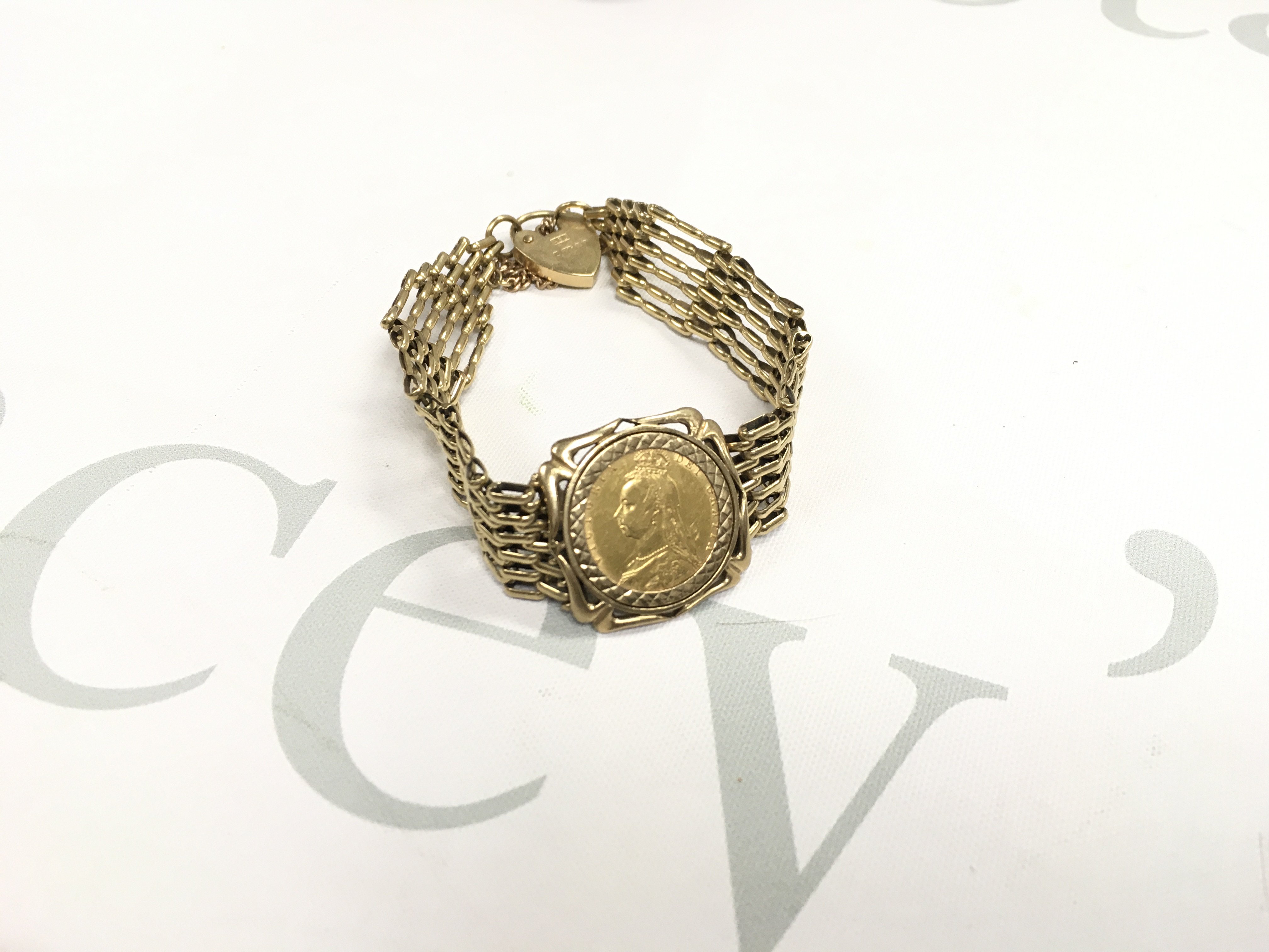An 1892 shield back full sovereign in a gate bracelet mount. Approx weight 22.26 grams.