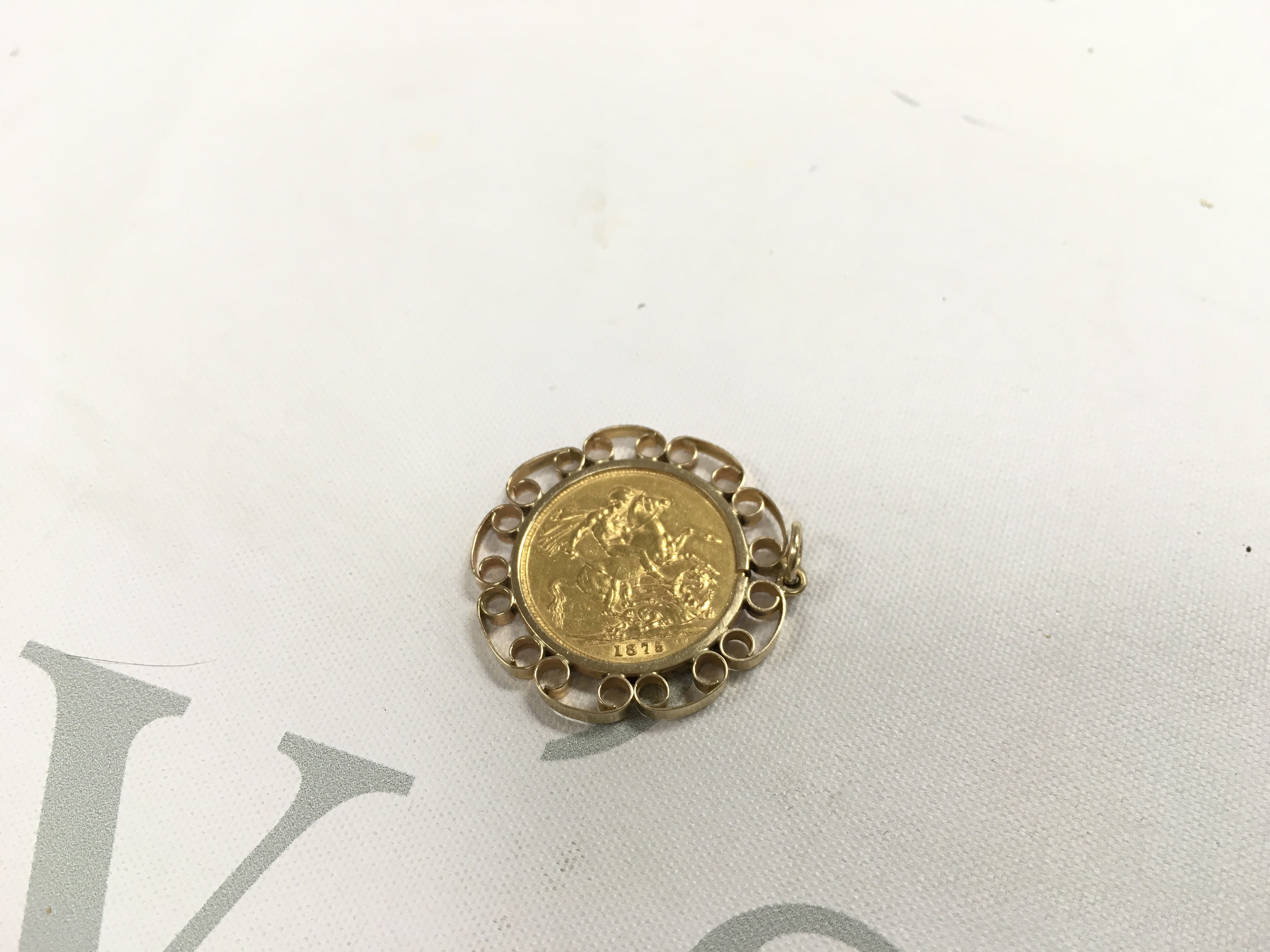 An 1875 sydney mint young head full sovereign in pendant mount. Approx weight 11.16 grams.