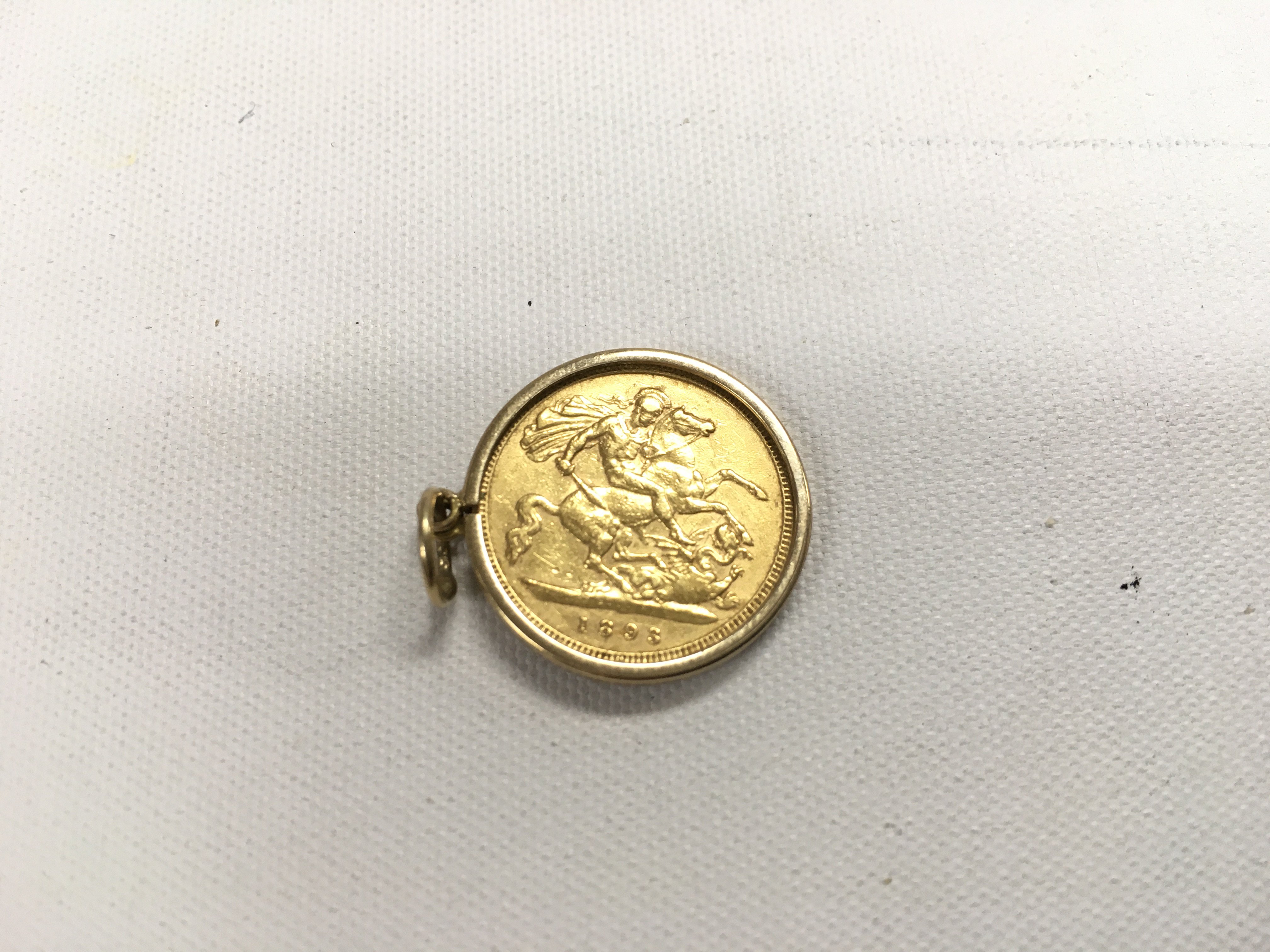 An 1893 half Sovereign (veiled head) in a 9ct pendant mount. Approx weight 4.99 grams.