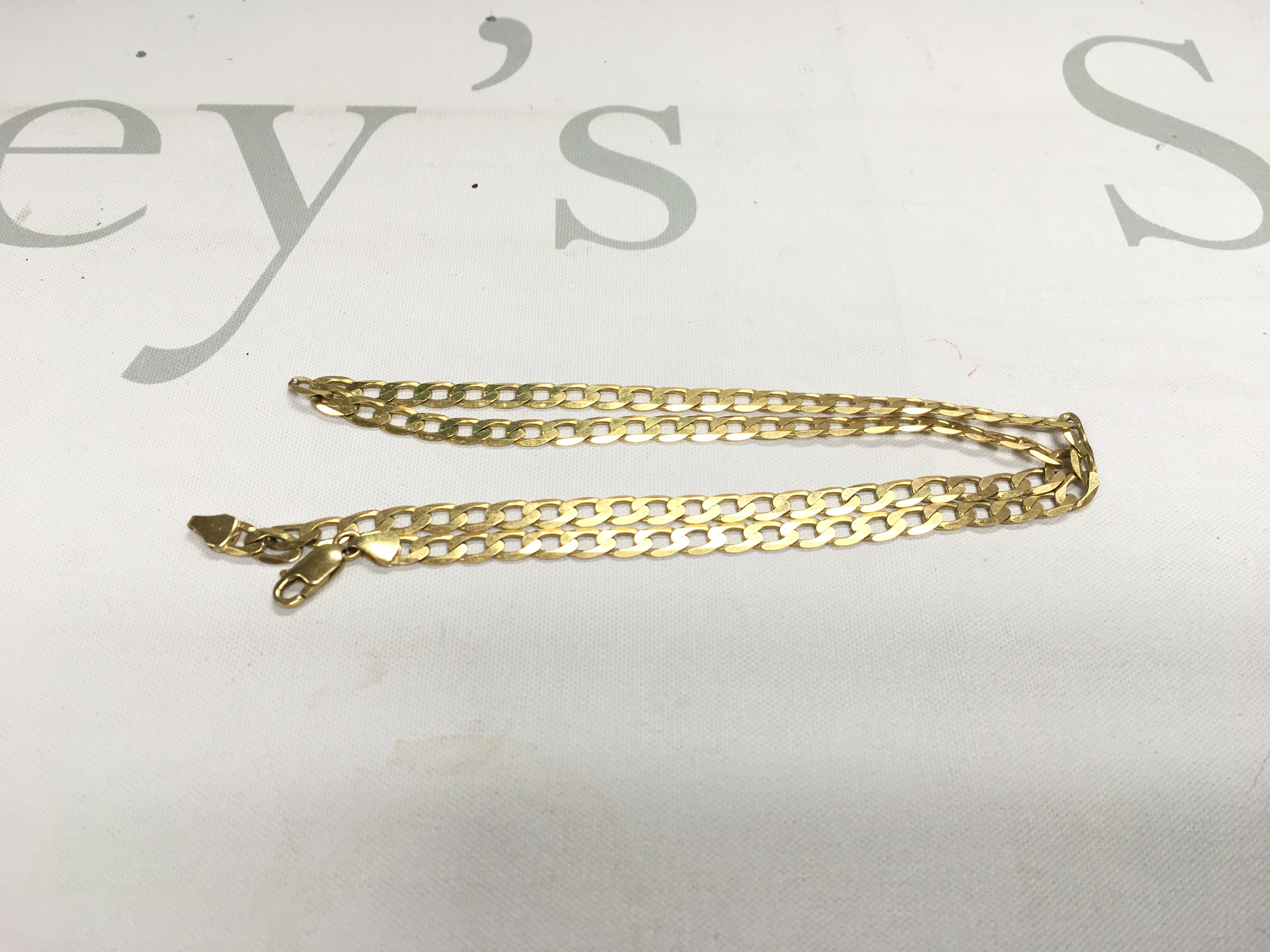A 9ct gold curb chain. Approx weight 15 grams.