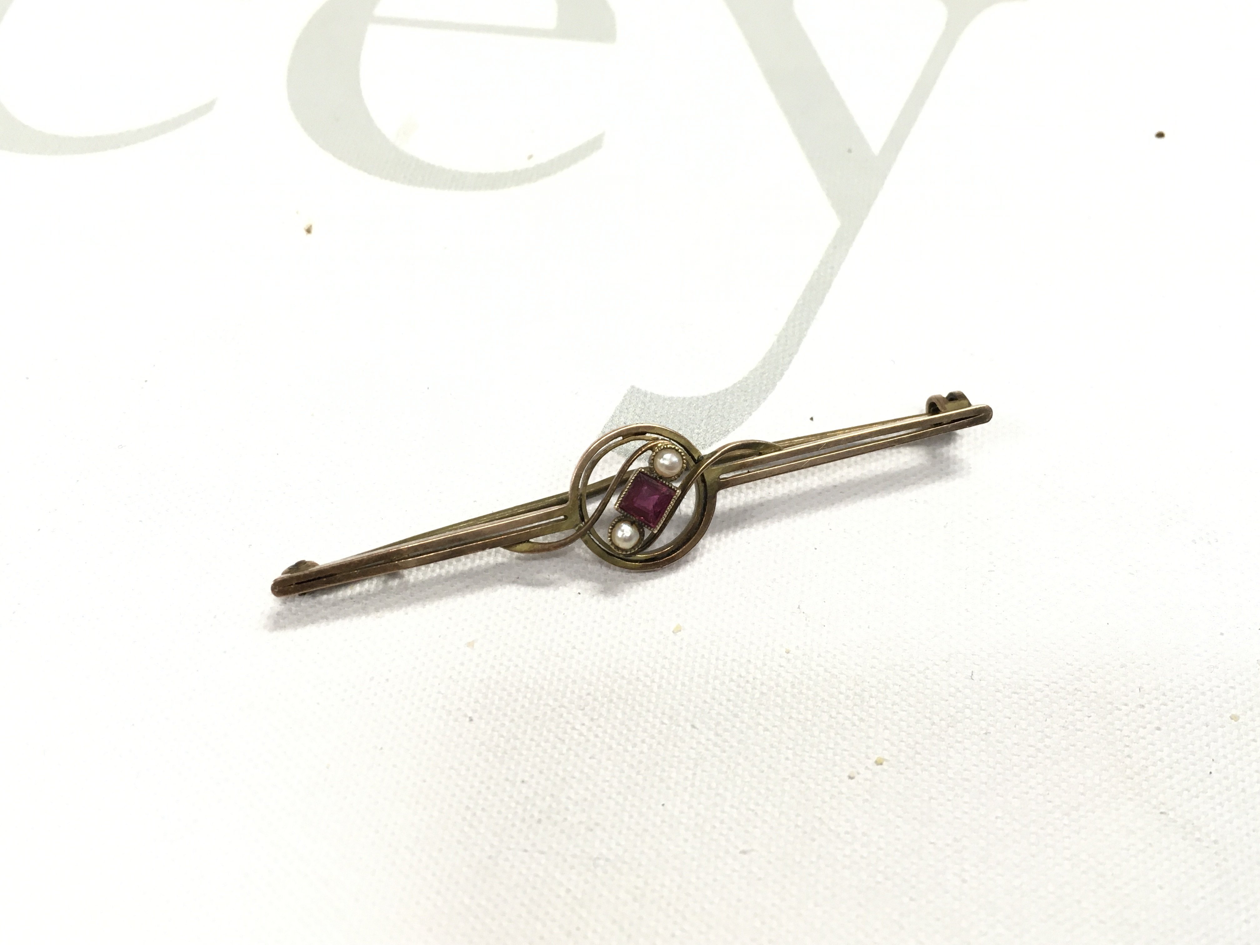 A 9ct gold ruby and pearl set brooch.