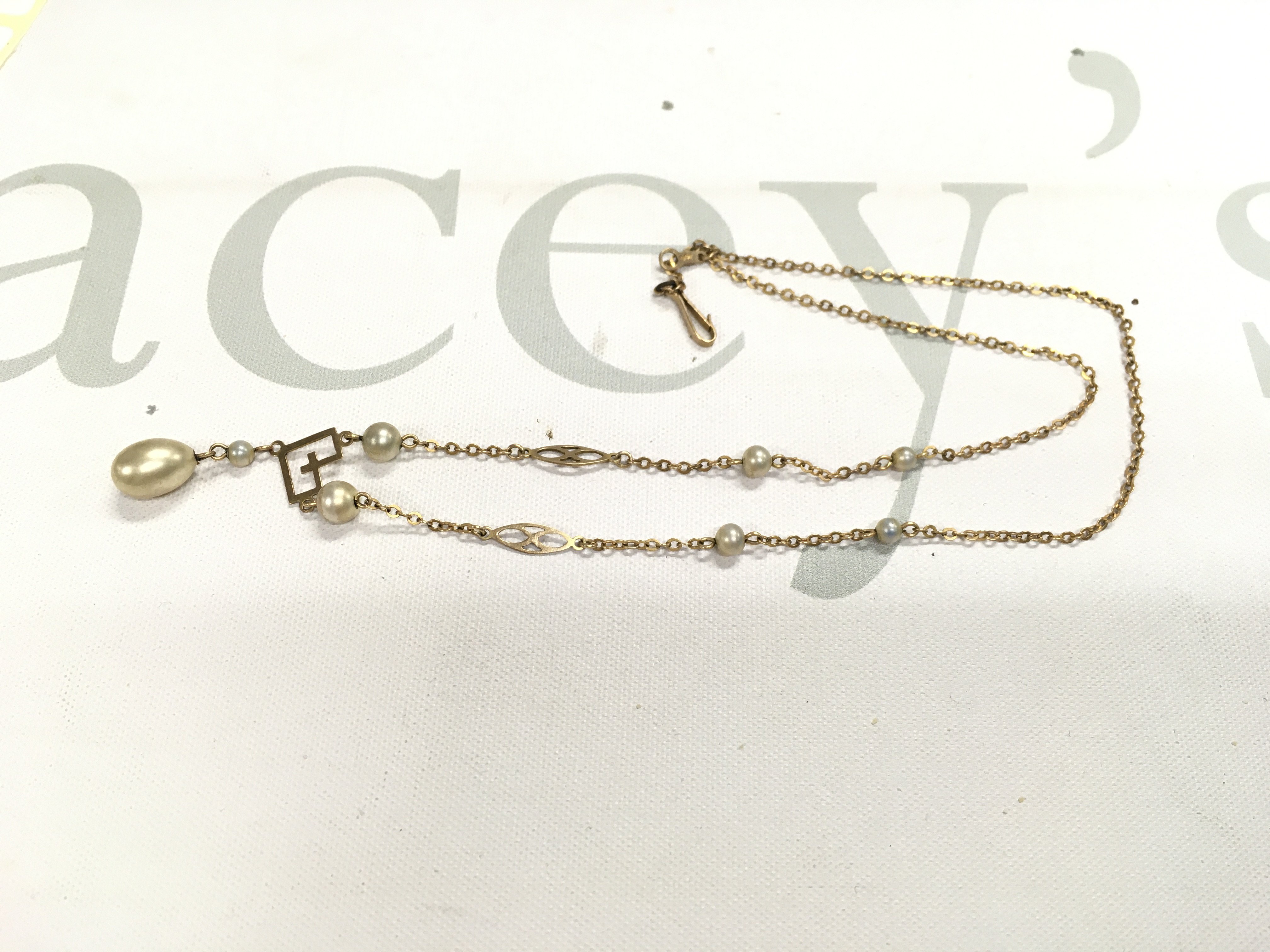 A 9ct gold and pearl necklace. Approx weight 3.80 grams.