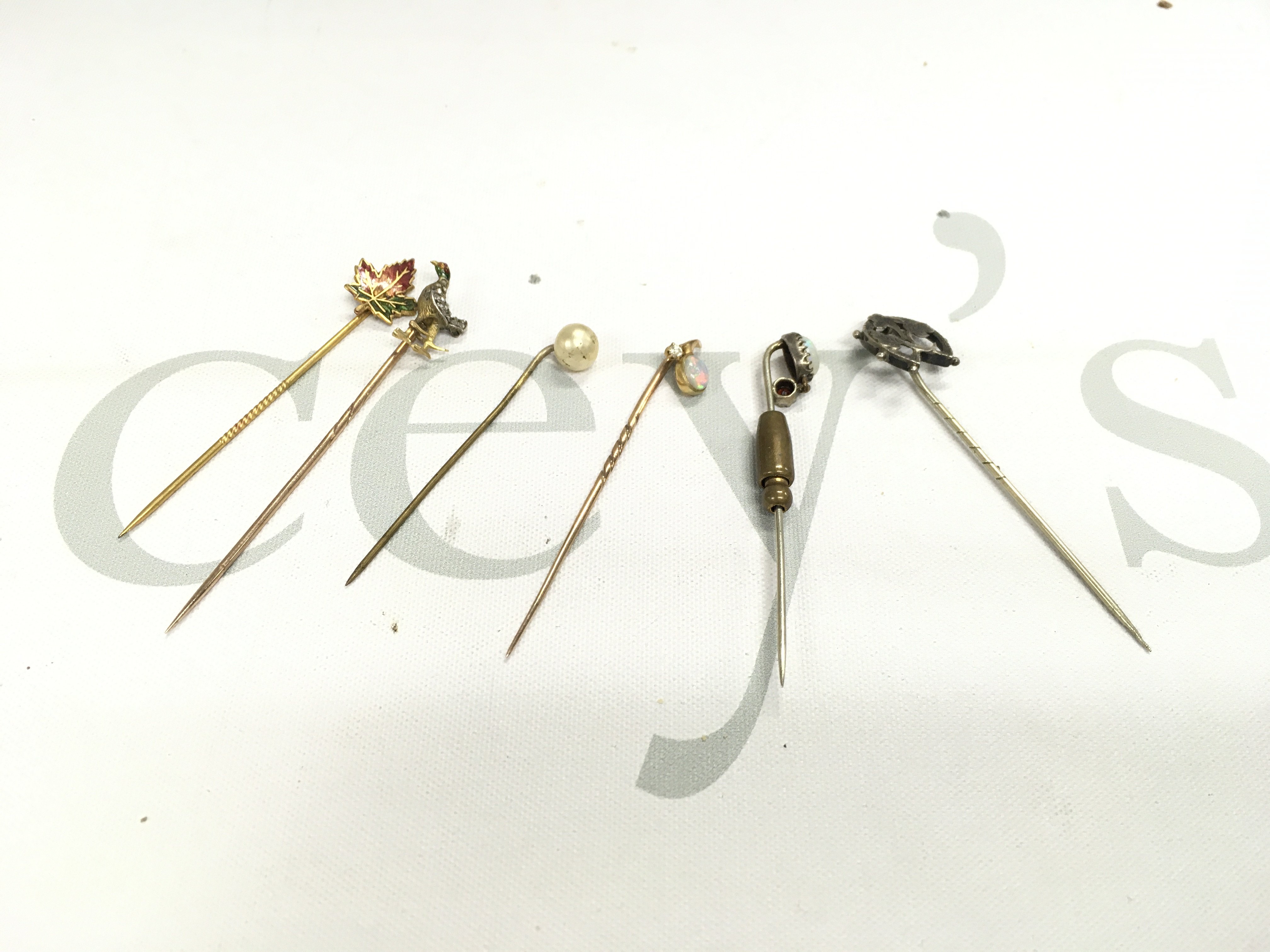 A small collection of pins including some gold examples.