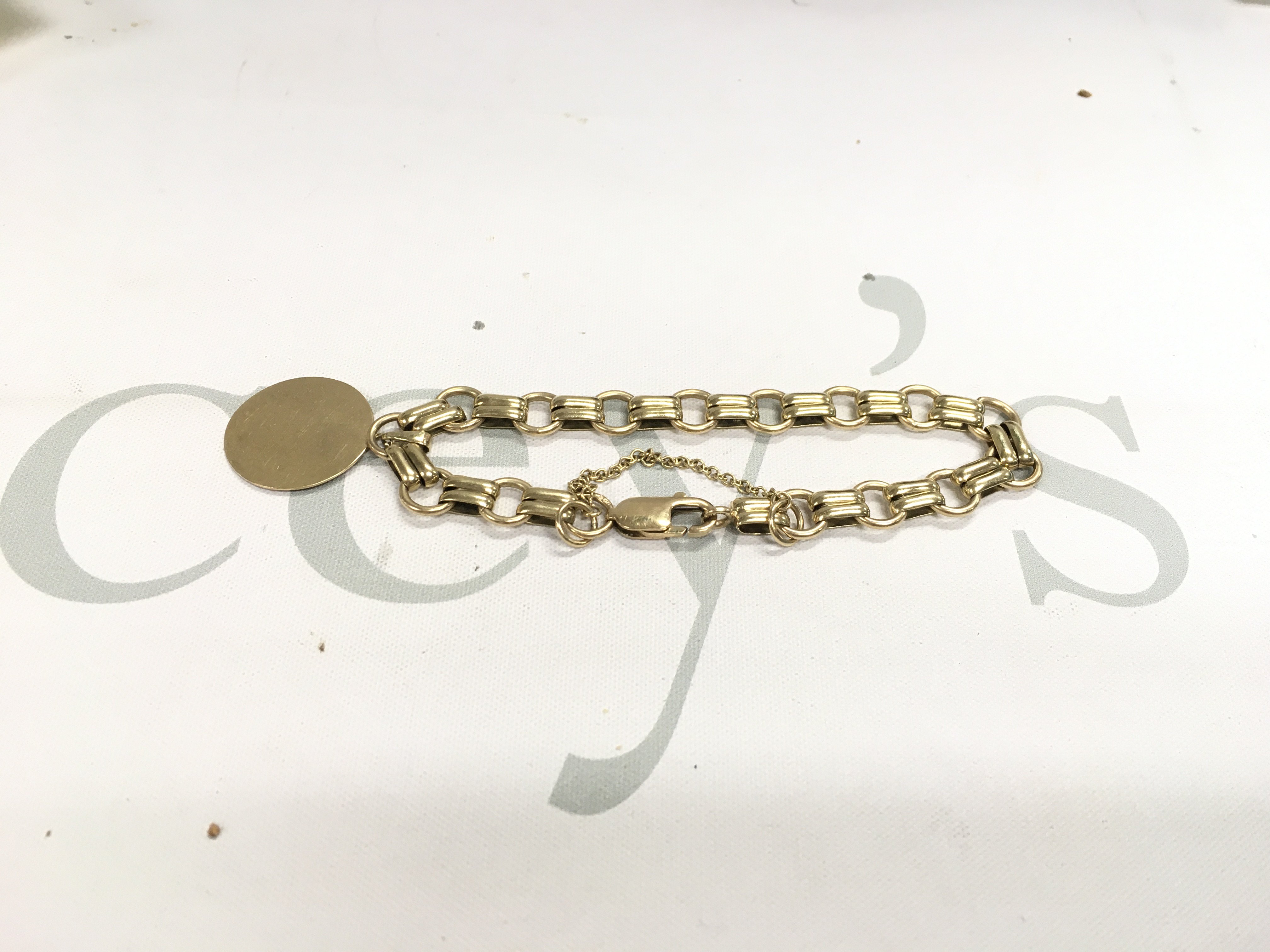 A 9ct gold special link bracelet with an attached ID tag. Approx weight 20.69 grams.