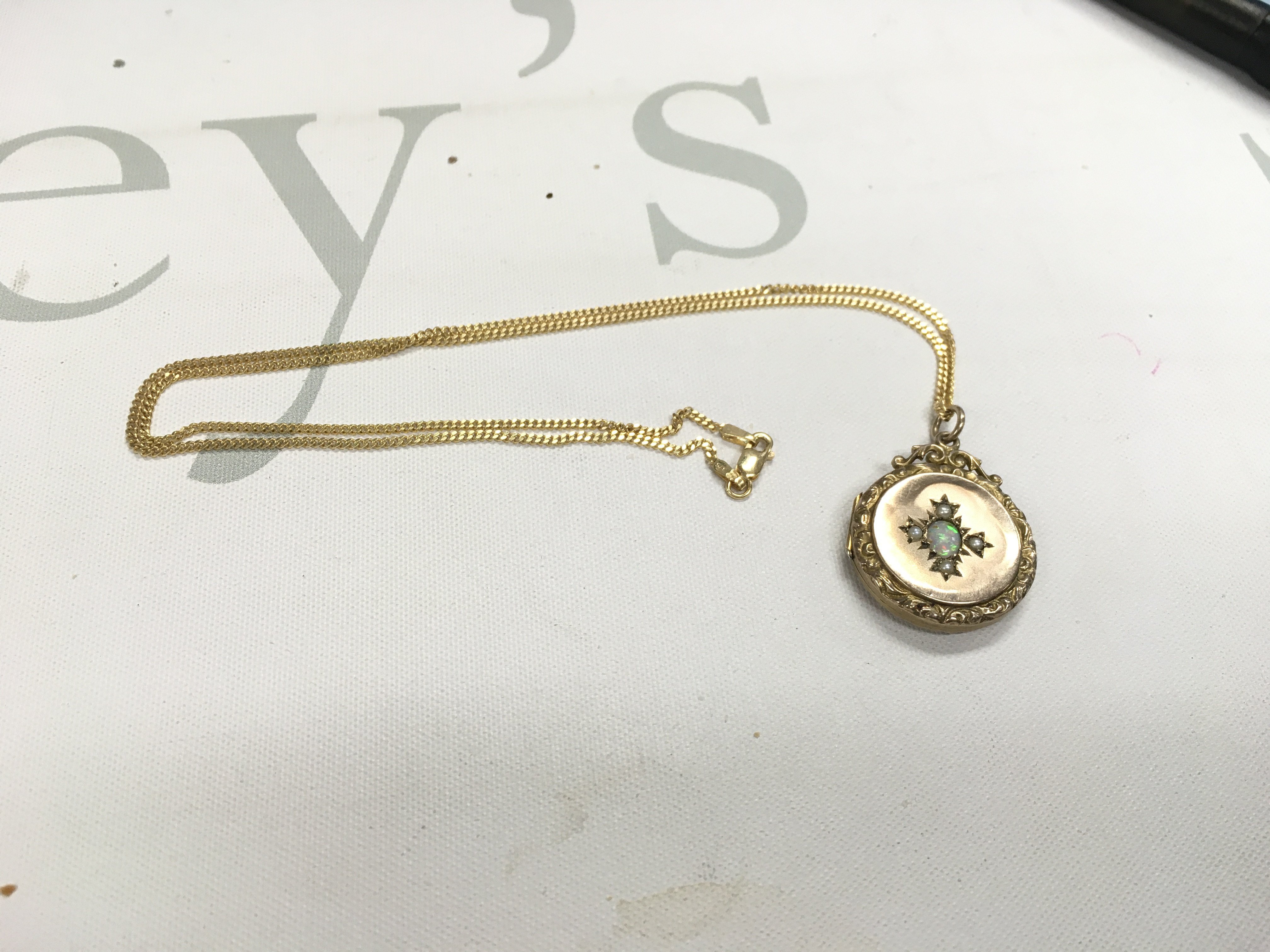 A 9ct gold chain and opal set pendant. Approx weight 7.99 grams.