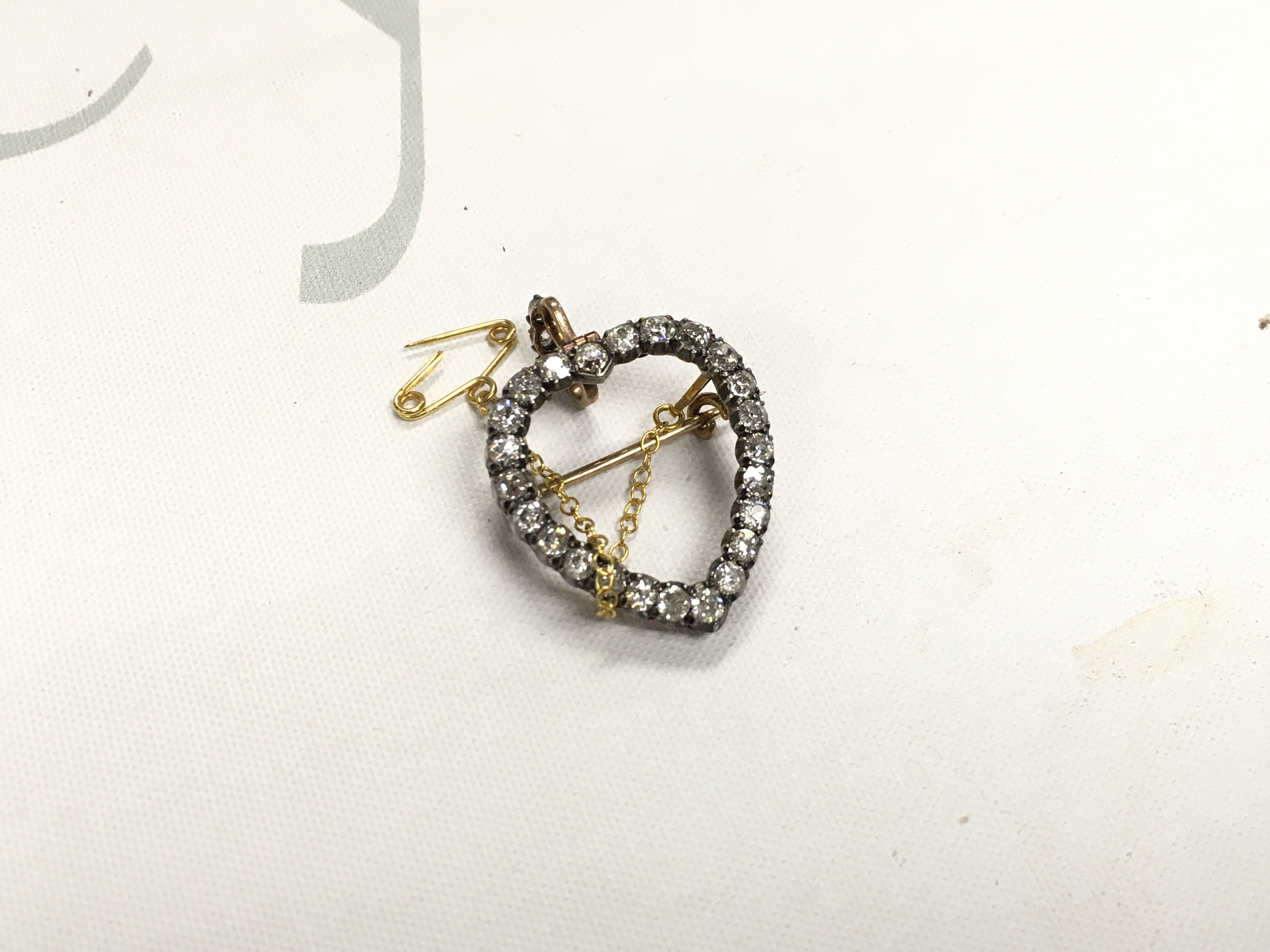 A diamond set open heart brooch.