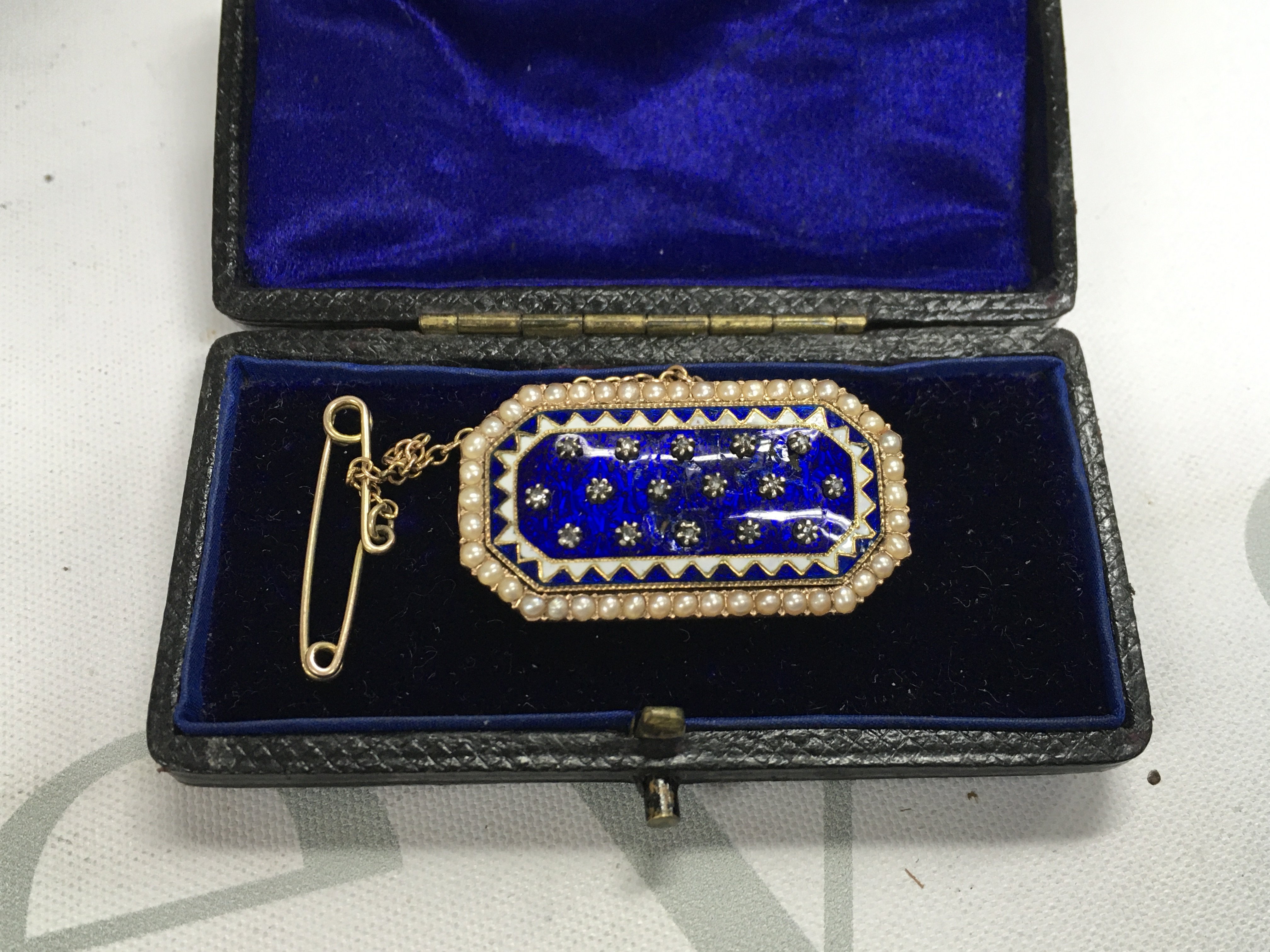A gold 19th century enamel brooch set with diamond chips. (Unmarked).