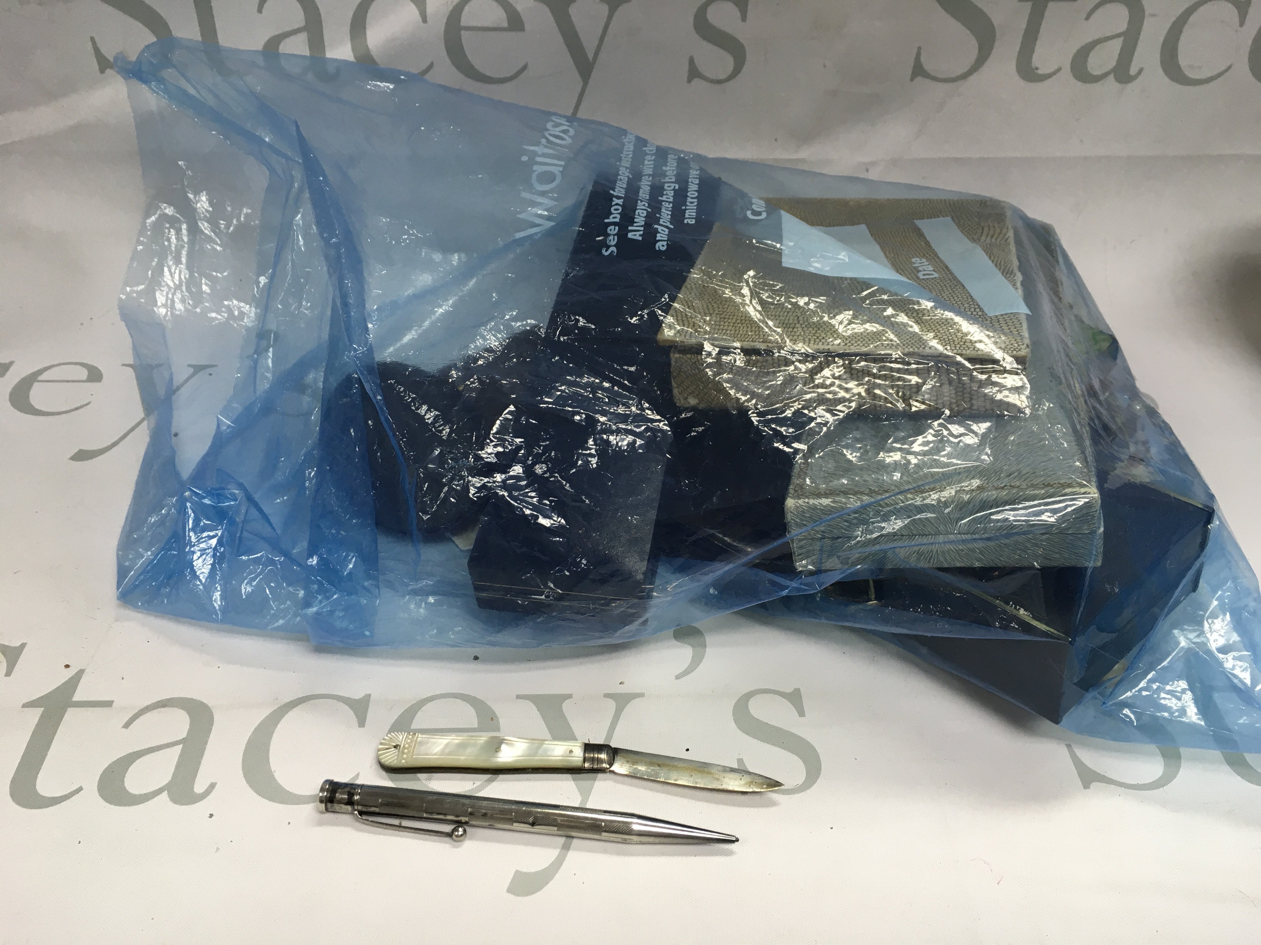 A collection of costume jewellery with a silver pen knife and silver pencil.