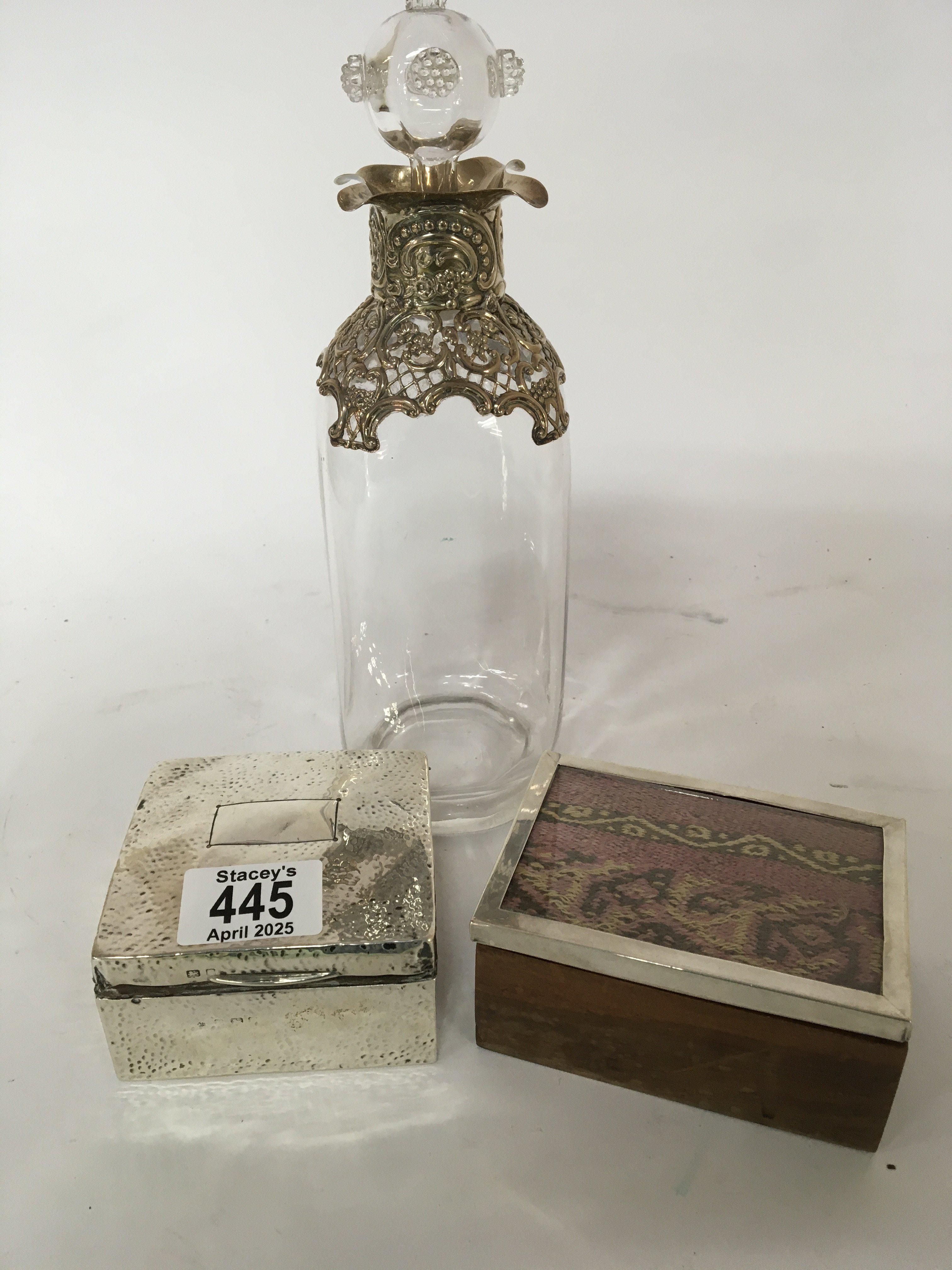 A Quality late 19th century bottle and stopper with applied silver mounts a silver cigarette box and one other hardwood box with a silver rim (3)