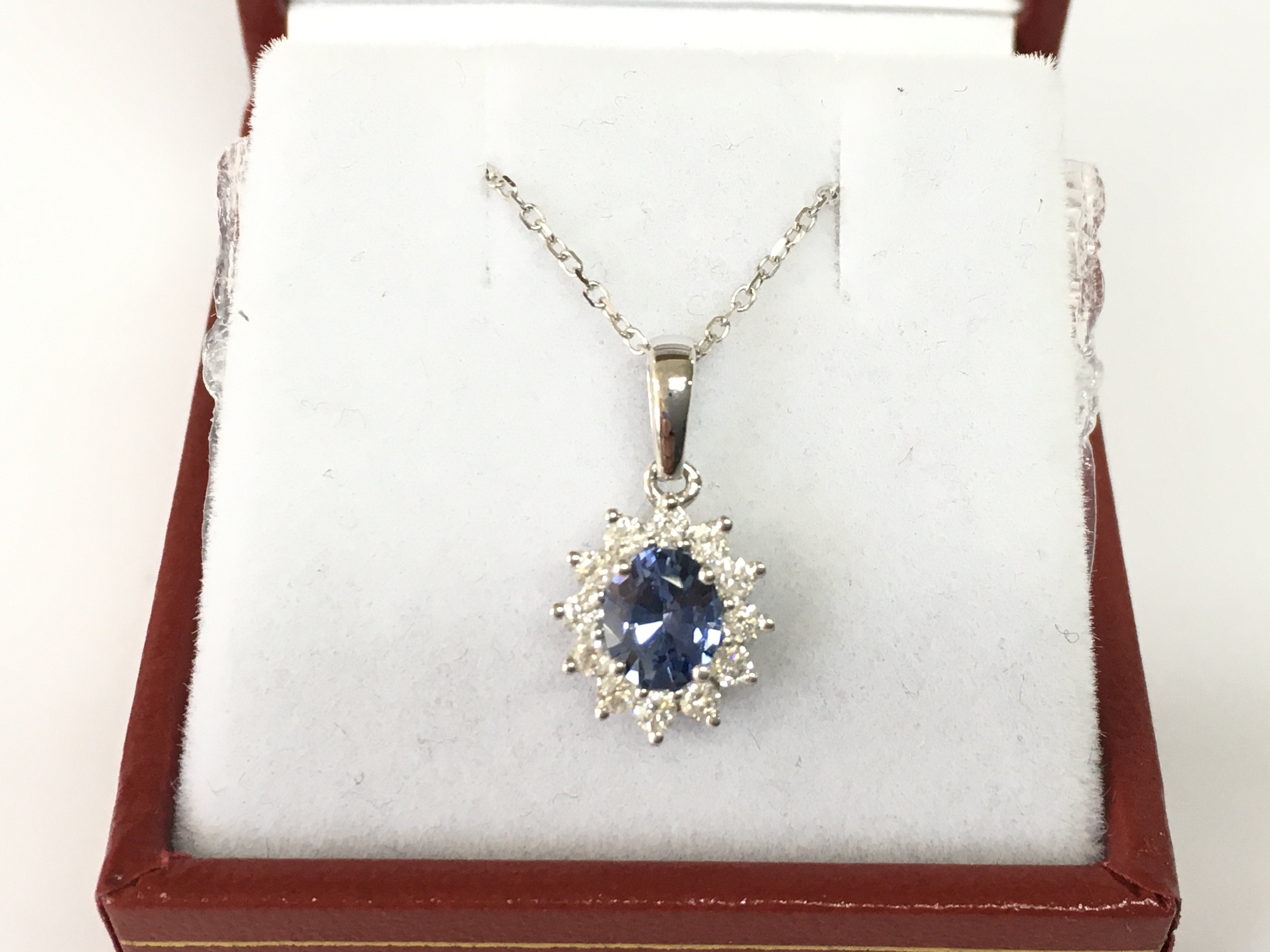 18ct white gold oval sapphire and RBC diamond pendant on an 18ct white gold chain. Sapphire 0.75ct and diamond 0.28ct Postage B