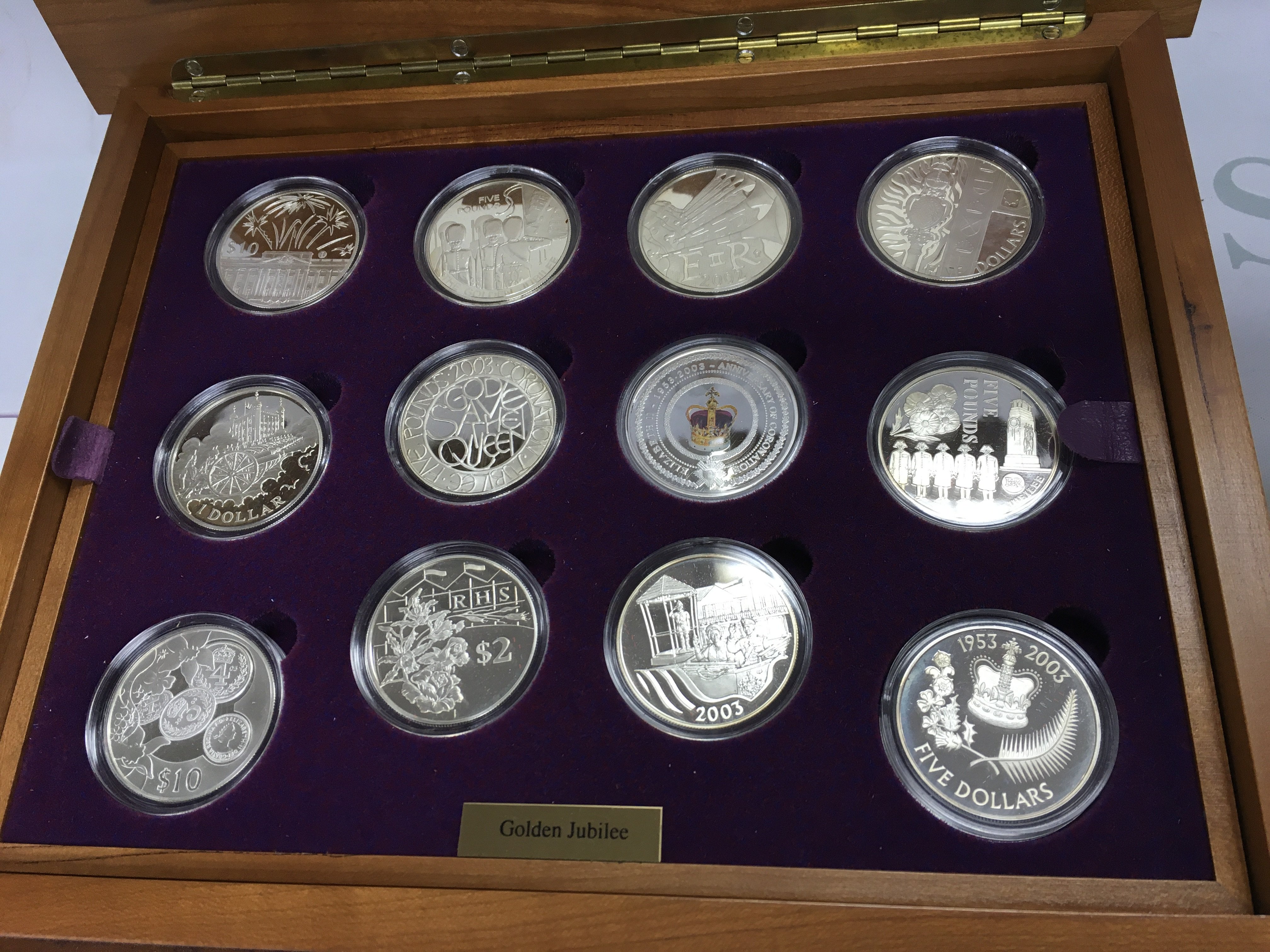 A sterling silver golden jubilee coin set containing 24 coins in nice wooden case. Postage B