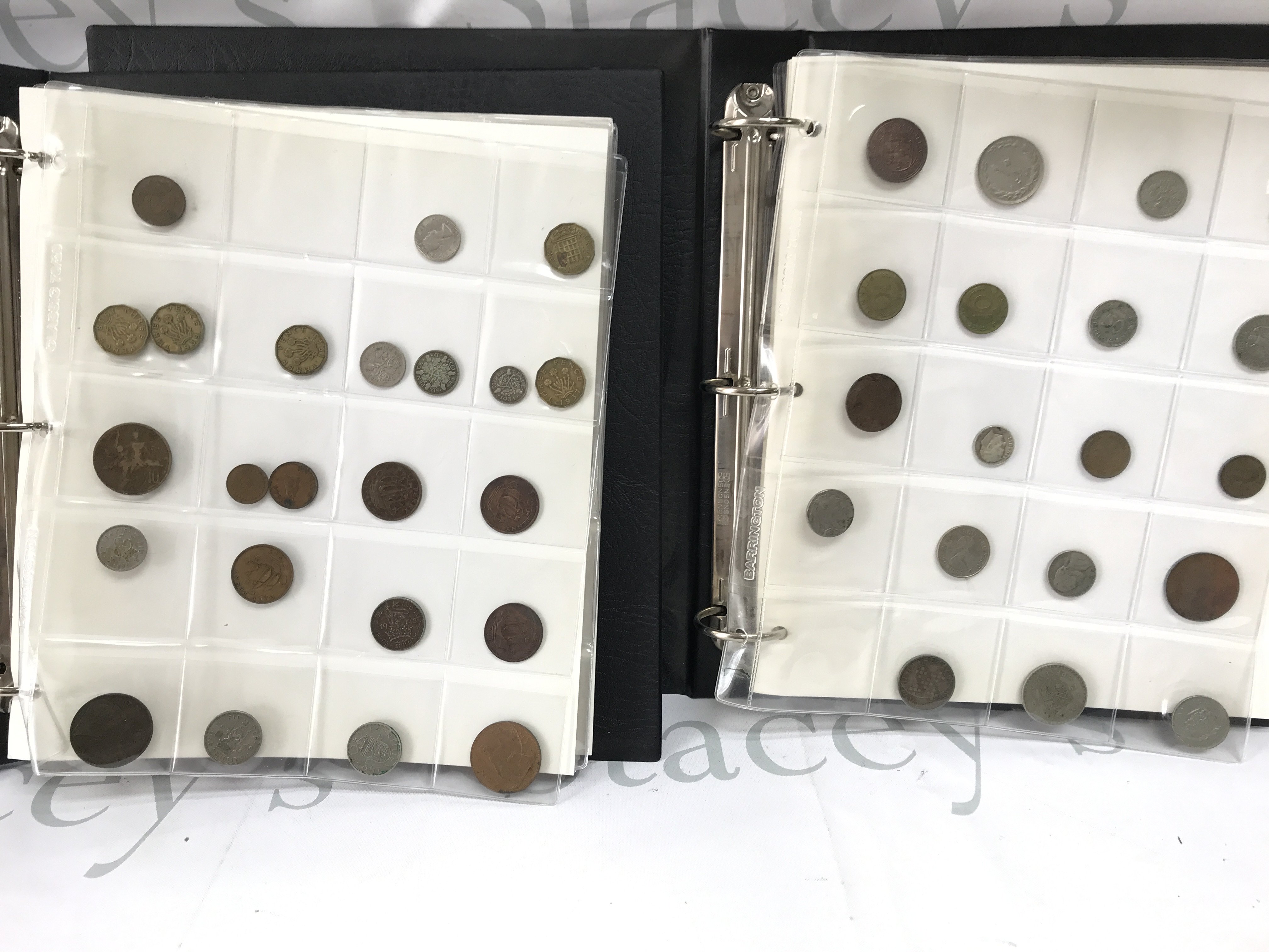 Two albums containing various circulated world coinage. Postage B