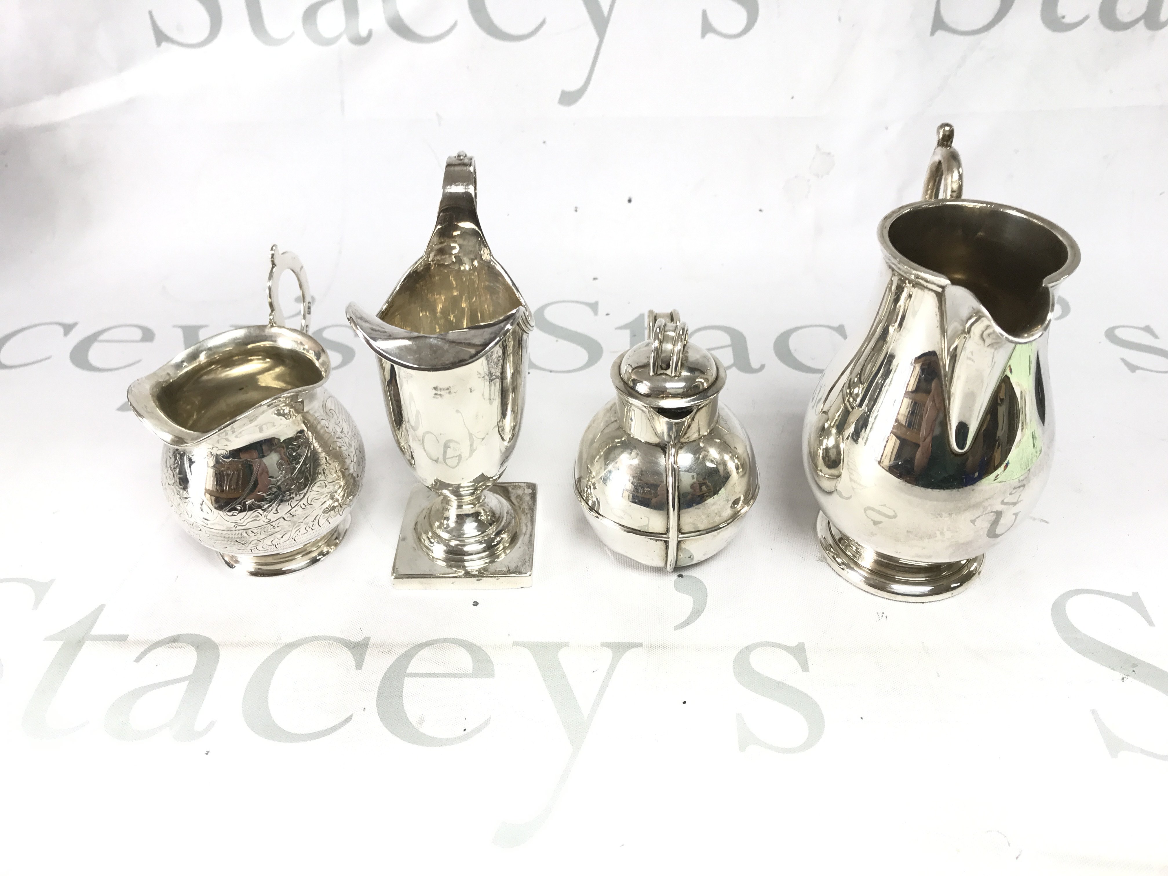 A collection of four silver jugs of assorted styles. Total weight 570g Postage B