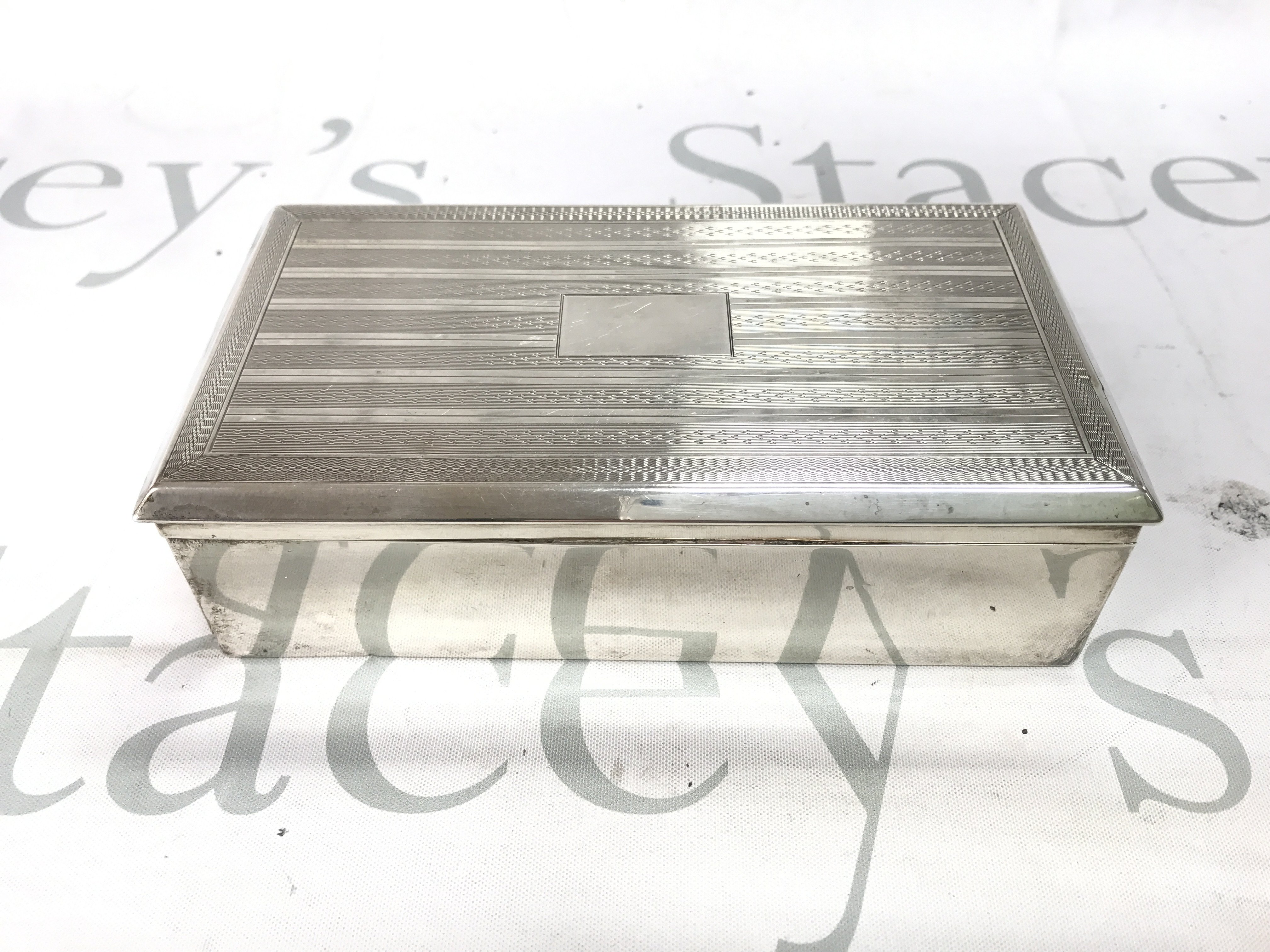 A vintage silver hallmarked cigarette box. 17.5cm wide 9.5cm deep.