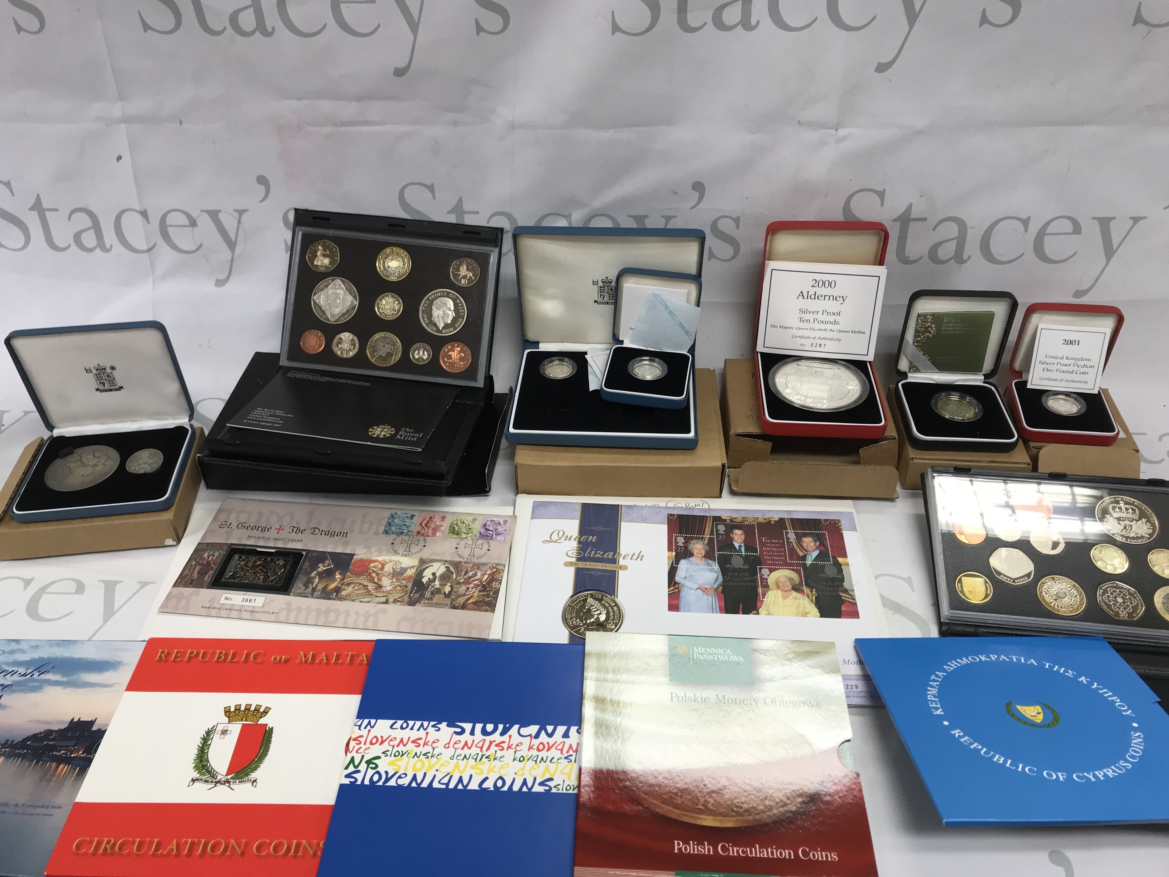A collection of coin sets and silver proof coins.