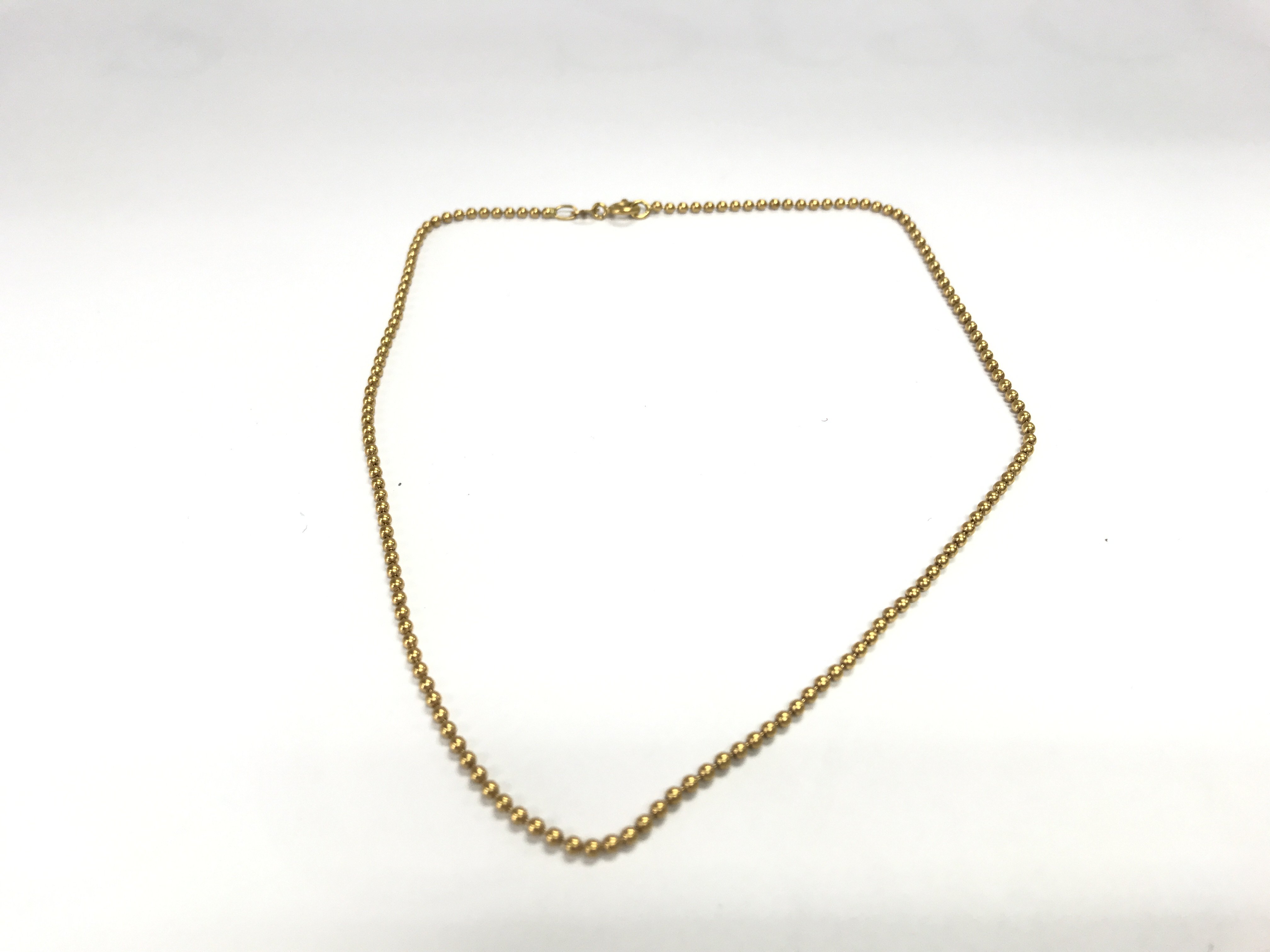 An 18ct gold bead necklace. 6.71g and 37cm long. Postage A