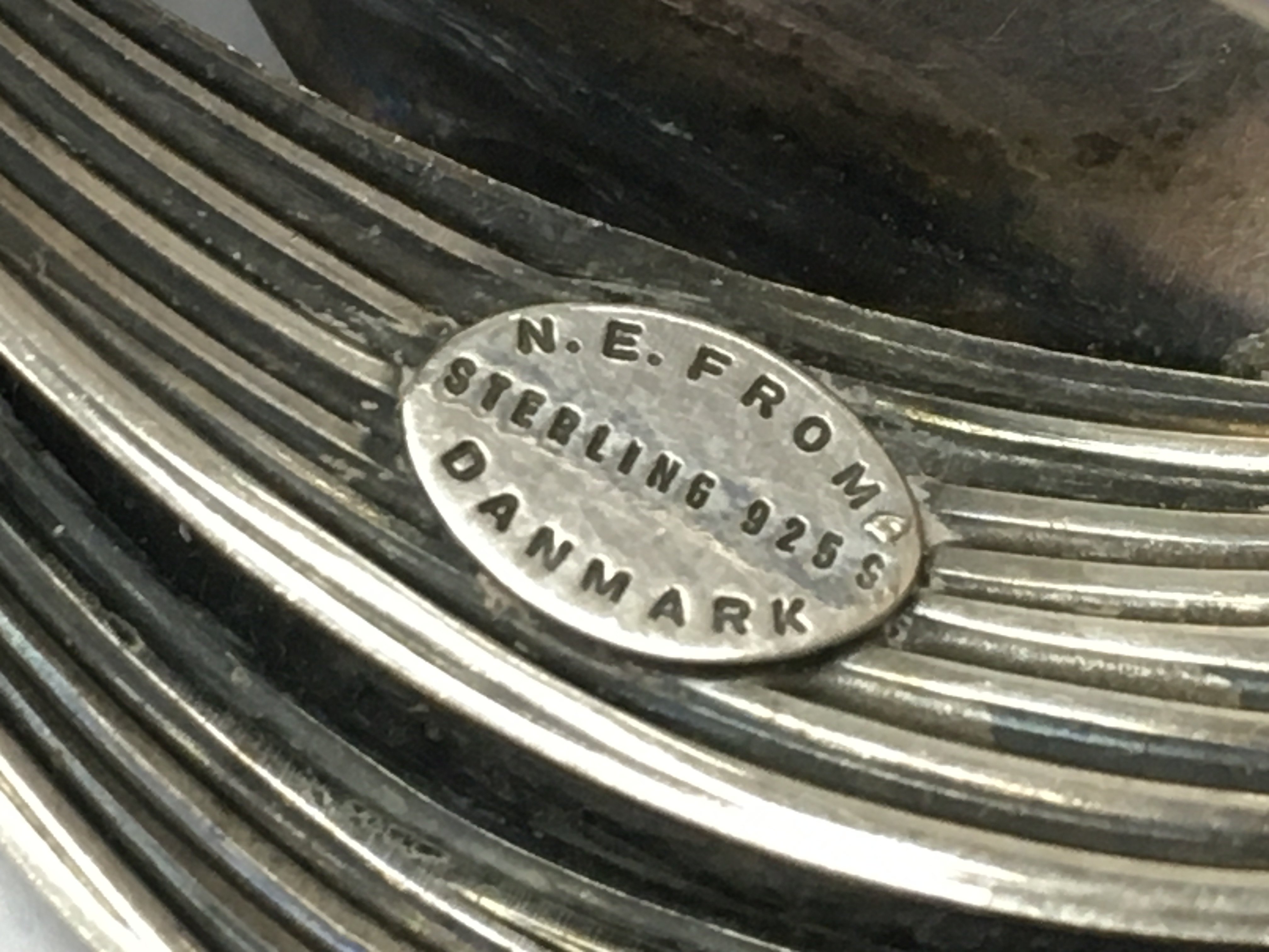 A silver brooch made in Denmark and a pair of earrings , postage category A. NO RESERVE