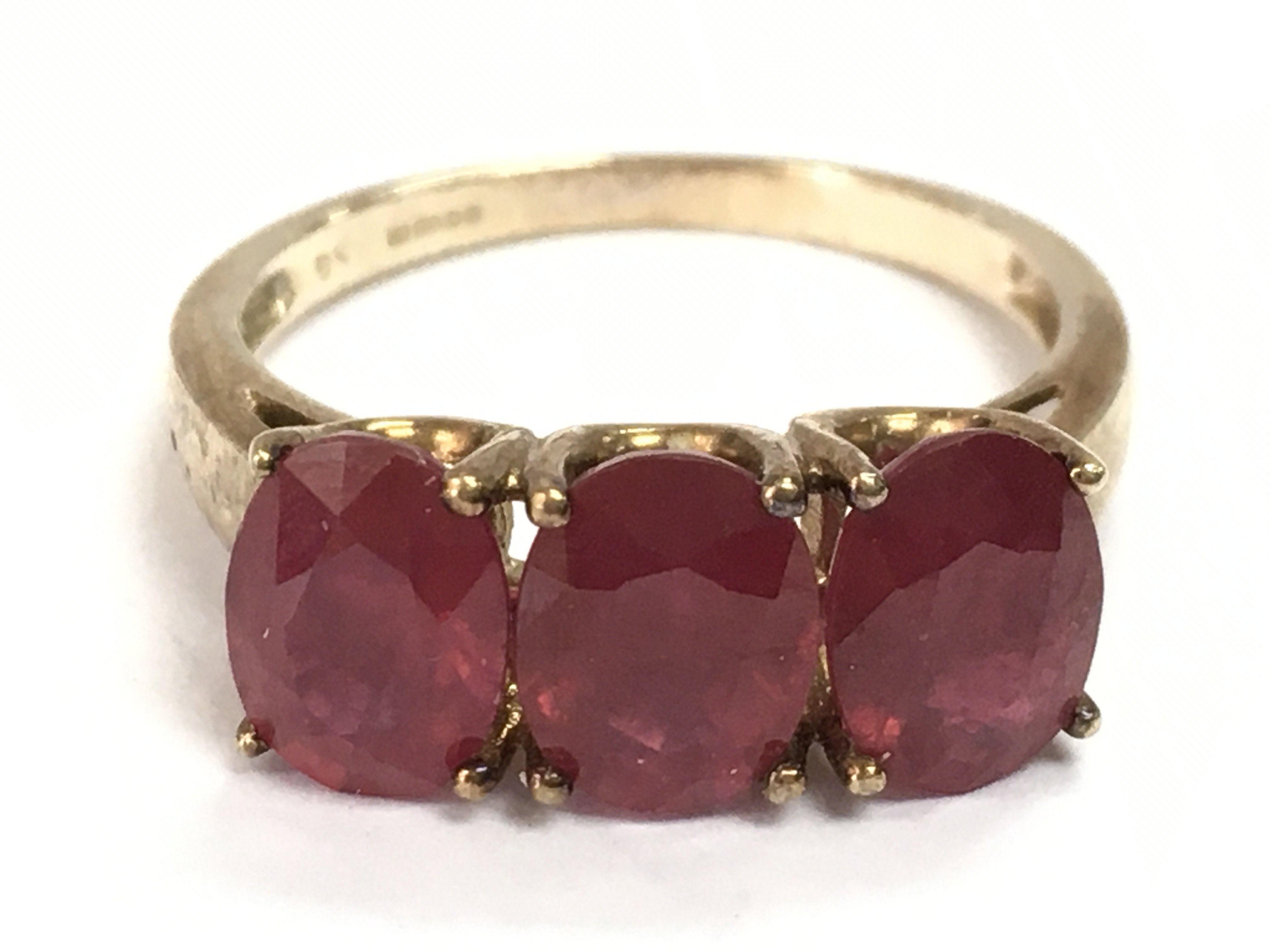 A 9ct gold ruby set three stone ring, R/S. 4.2g total weight. postage catA