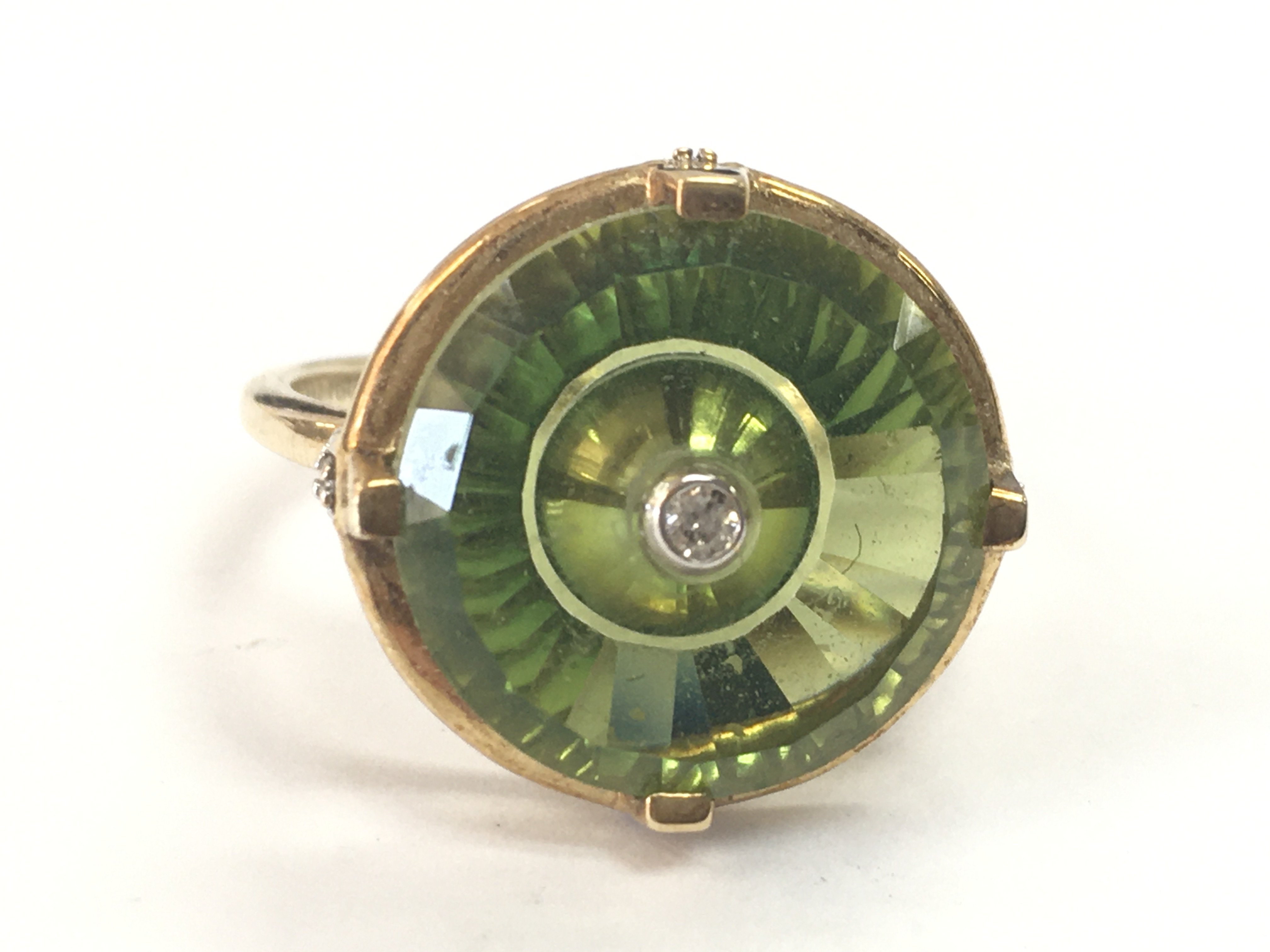 A 9ct gold green quartz and diamond stone ring. P/Q .4.4g total weight. Postage category A