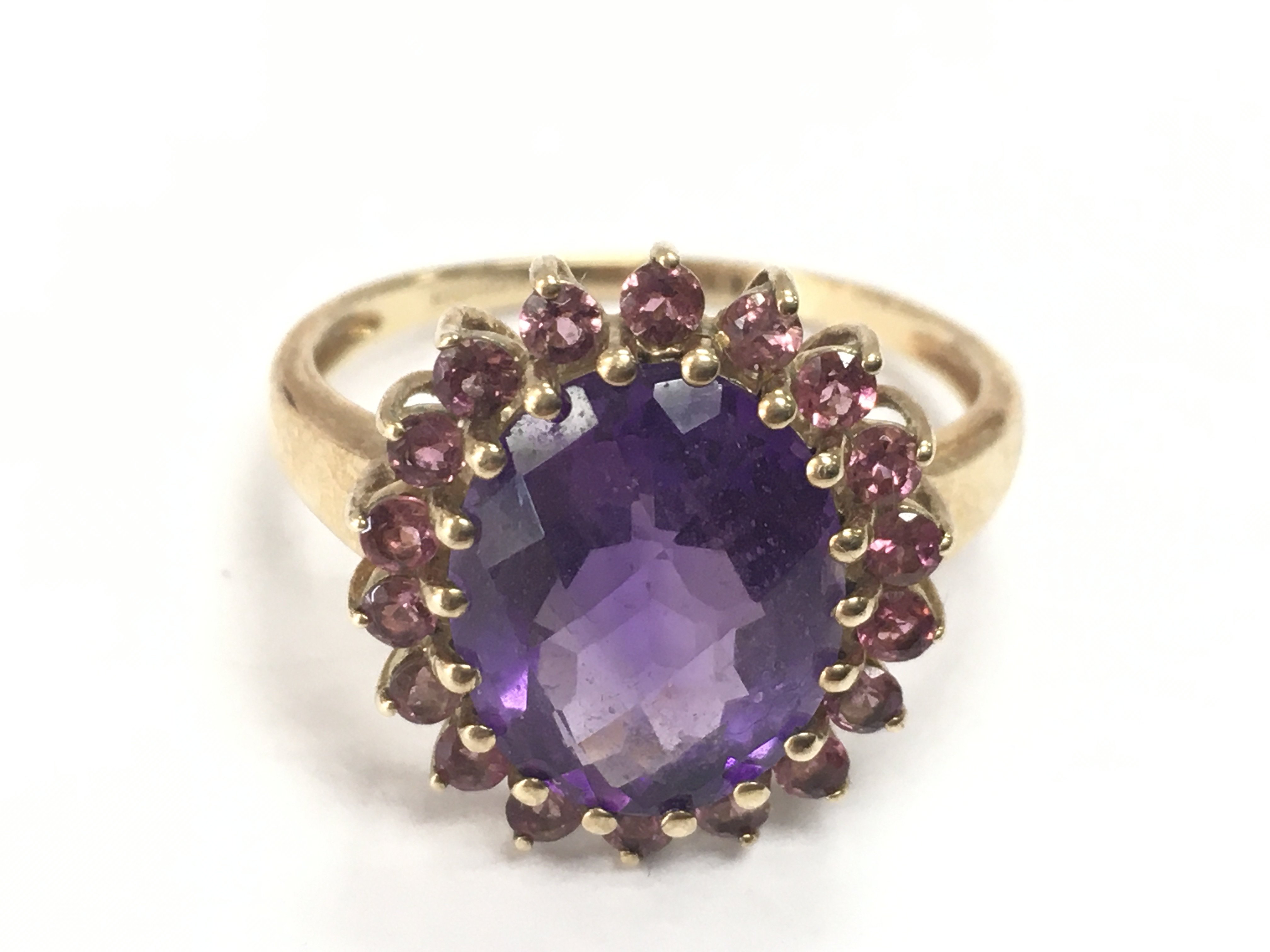 A 9ct gold purple amethyst and rhodolite ring, size R/S. 4g total weight. postage category A